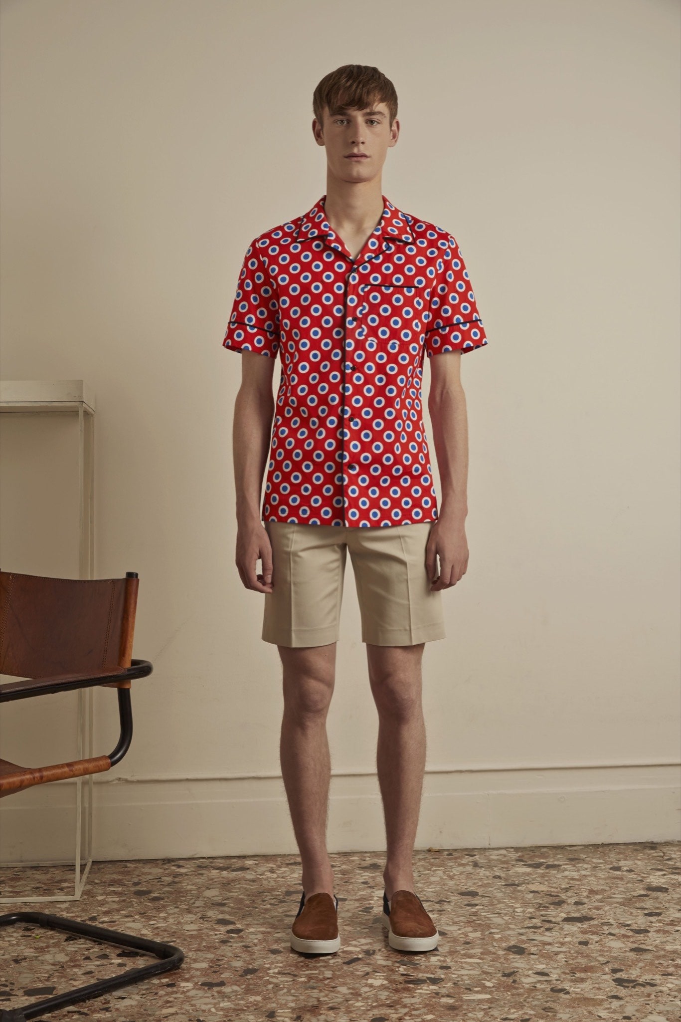 red printed short-sleeve shirt with beige shorts