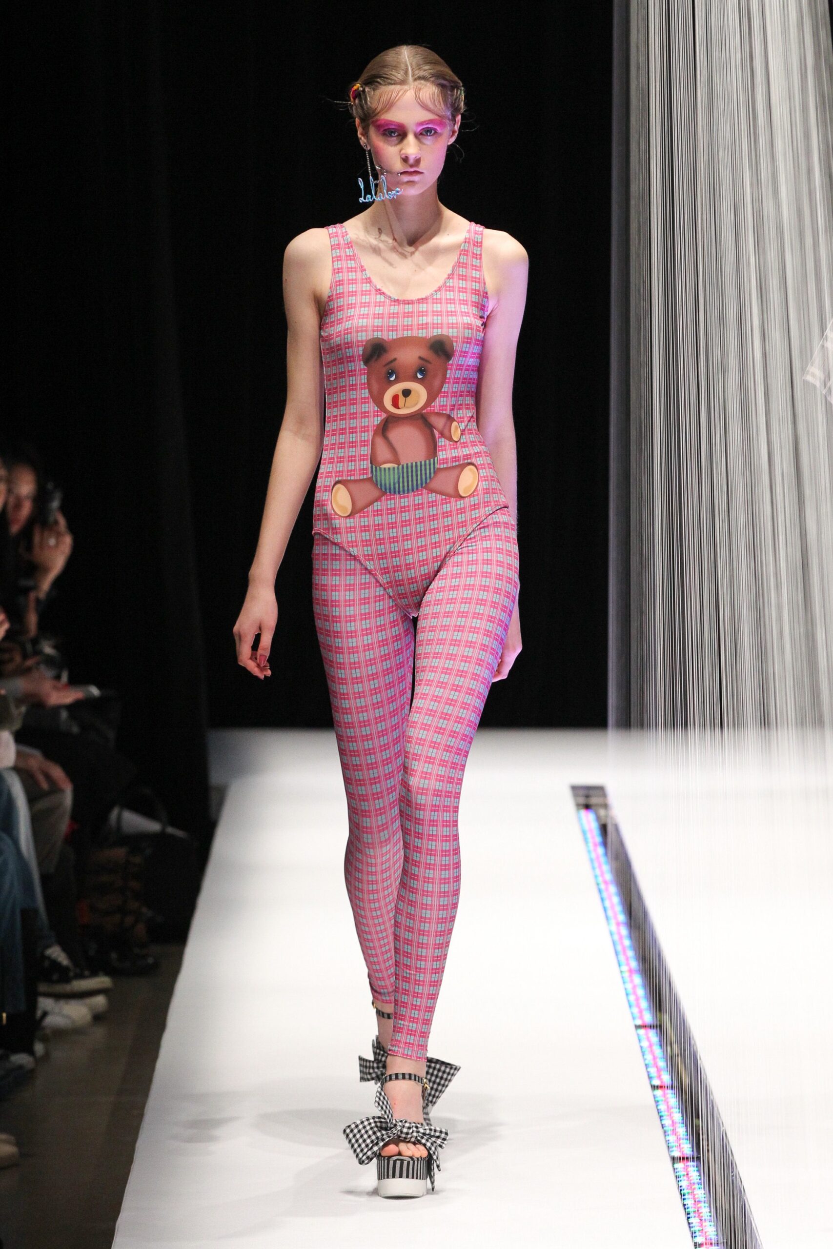 pink printed catsuit with checkered shoes