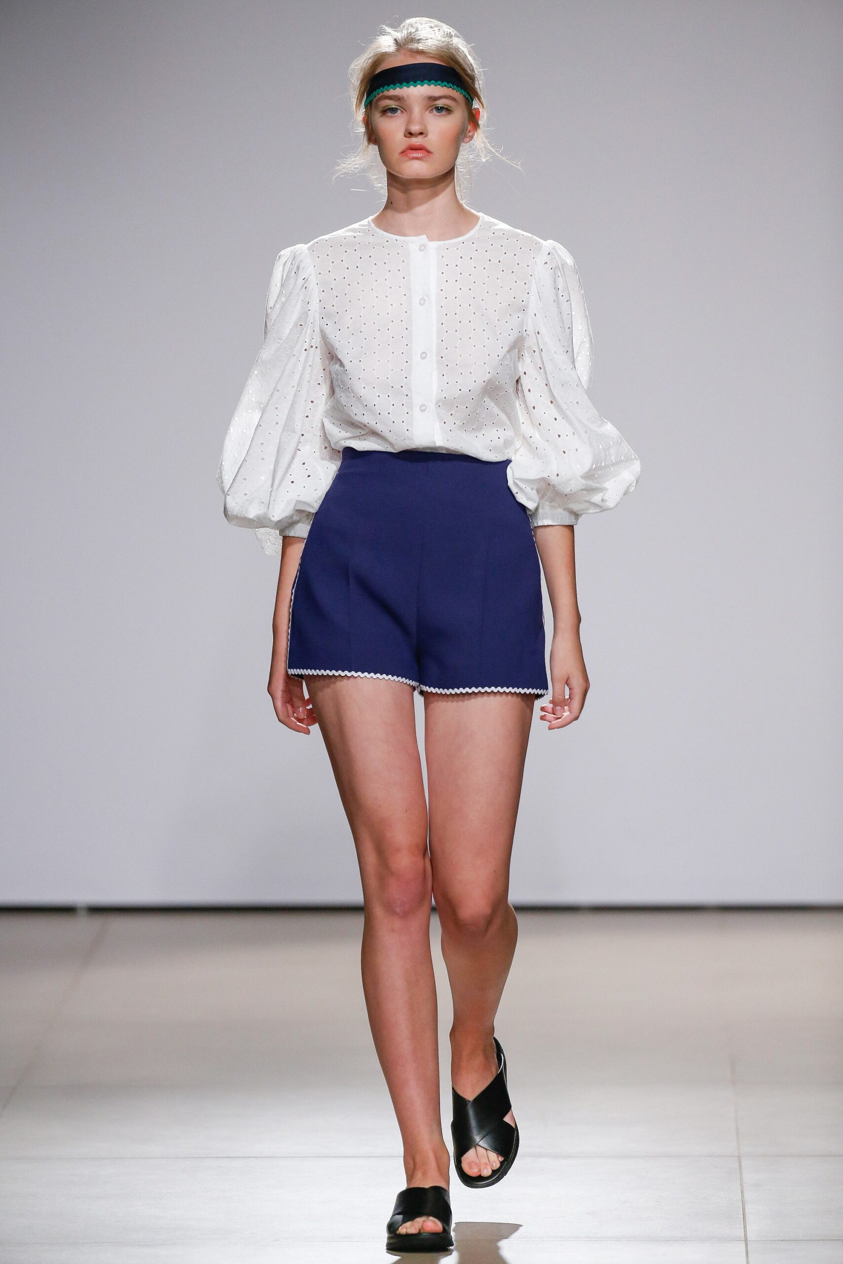 white blouse and blue shorts