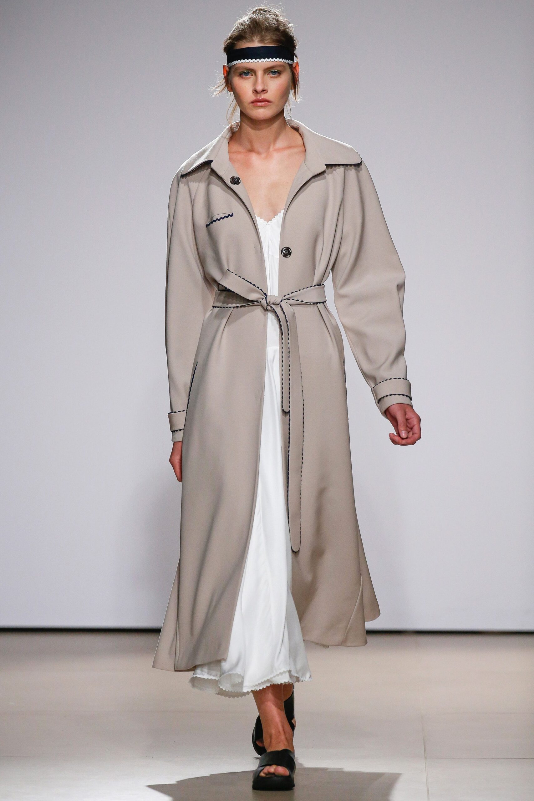 beige coat over white dress