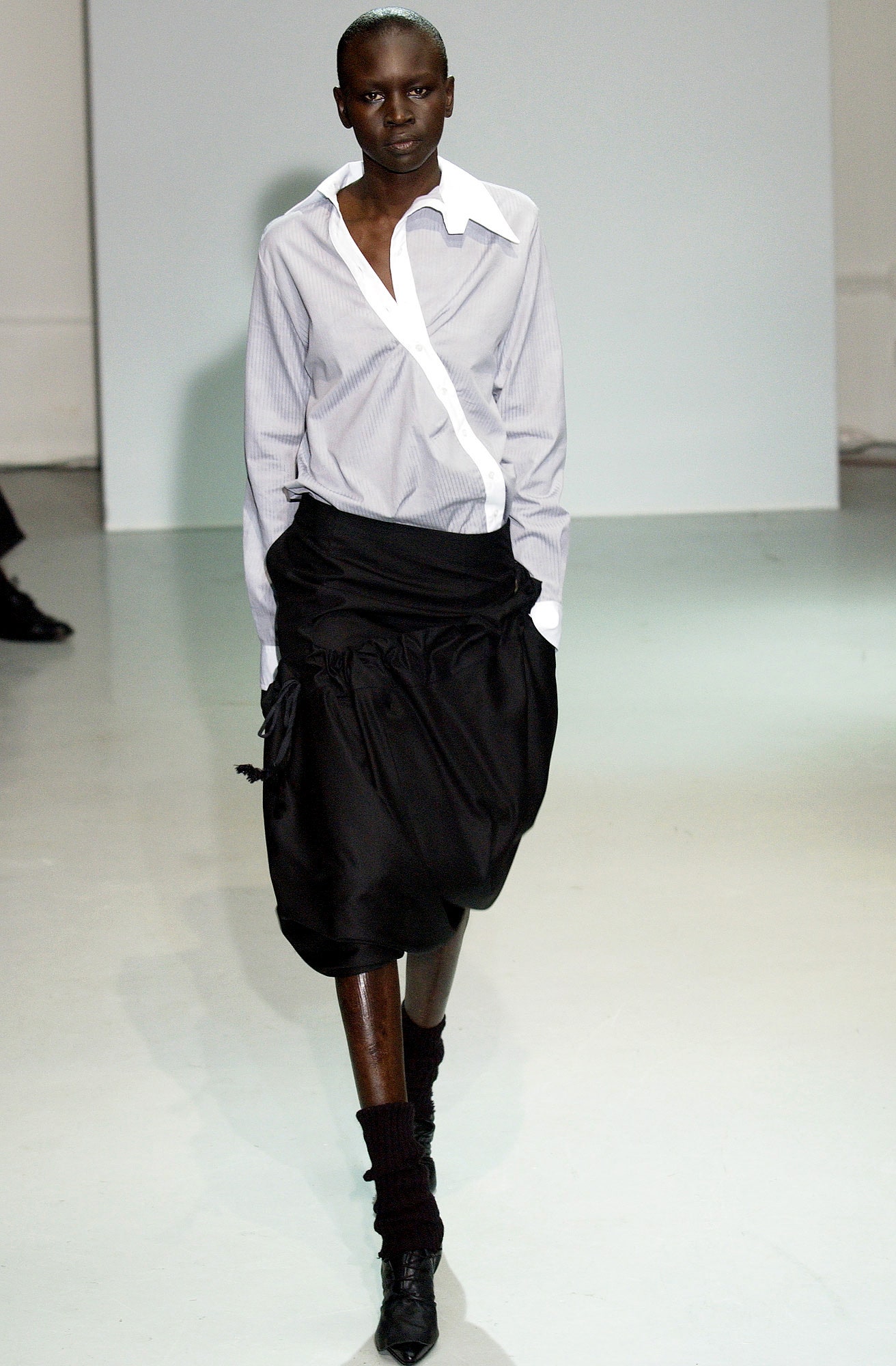 white blue striped shirt black pleated skirt