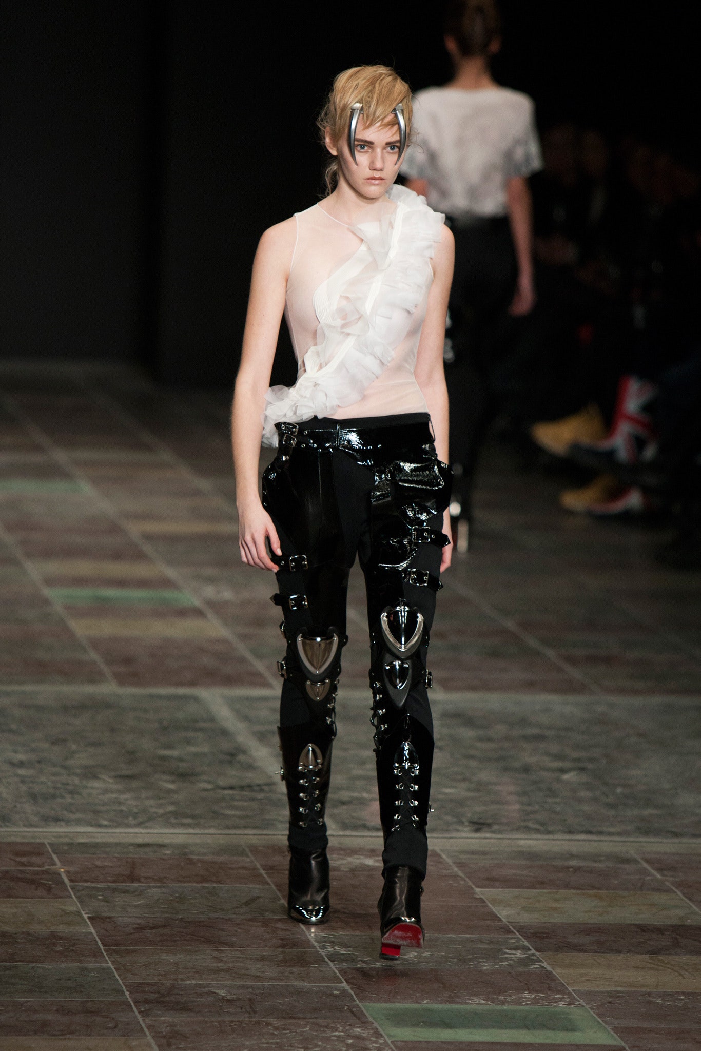 white ruffled top and black vinyl pants