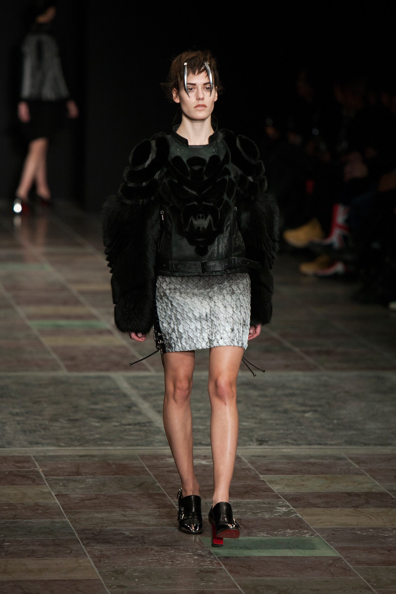 black leather fitted jacket and gray pleated mini skirt