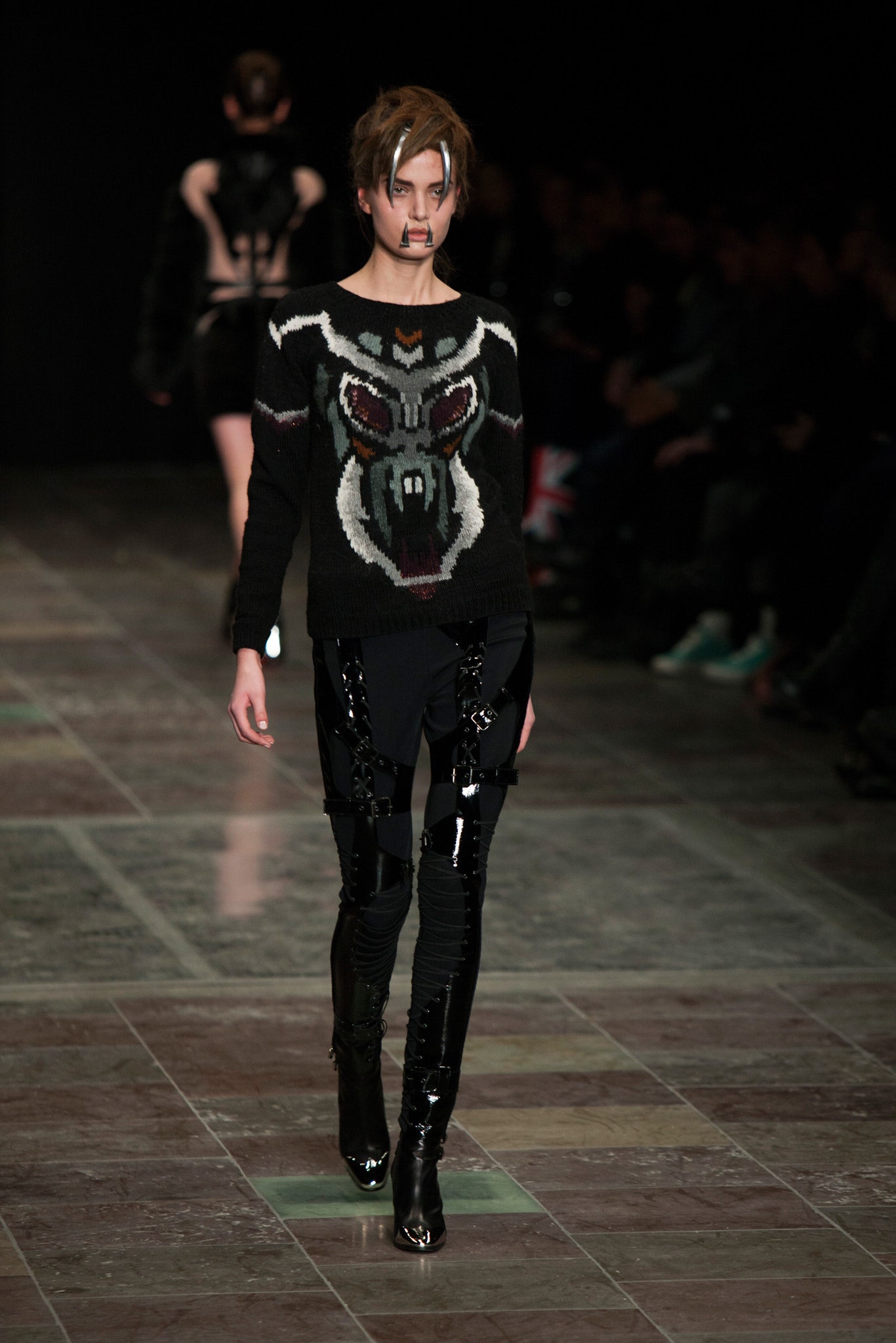 black embroidered sweater with vinyl pants