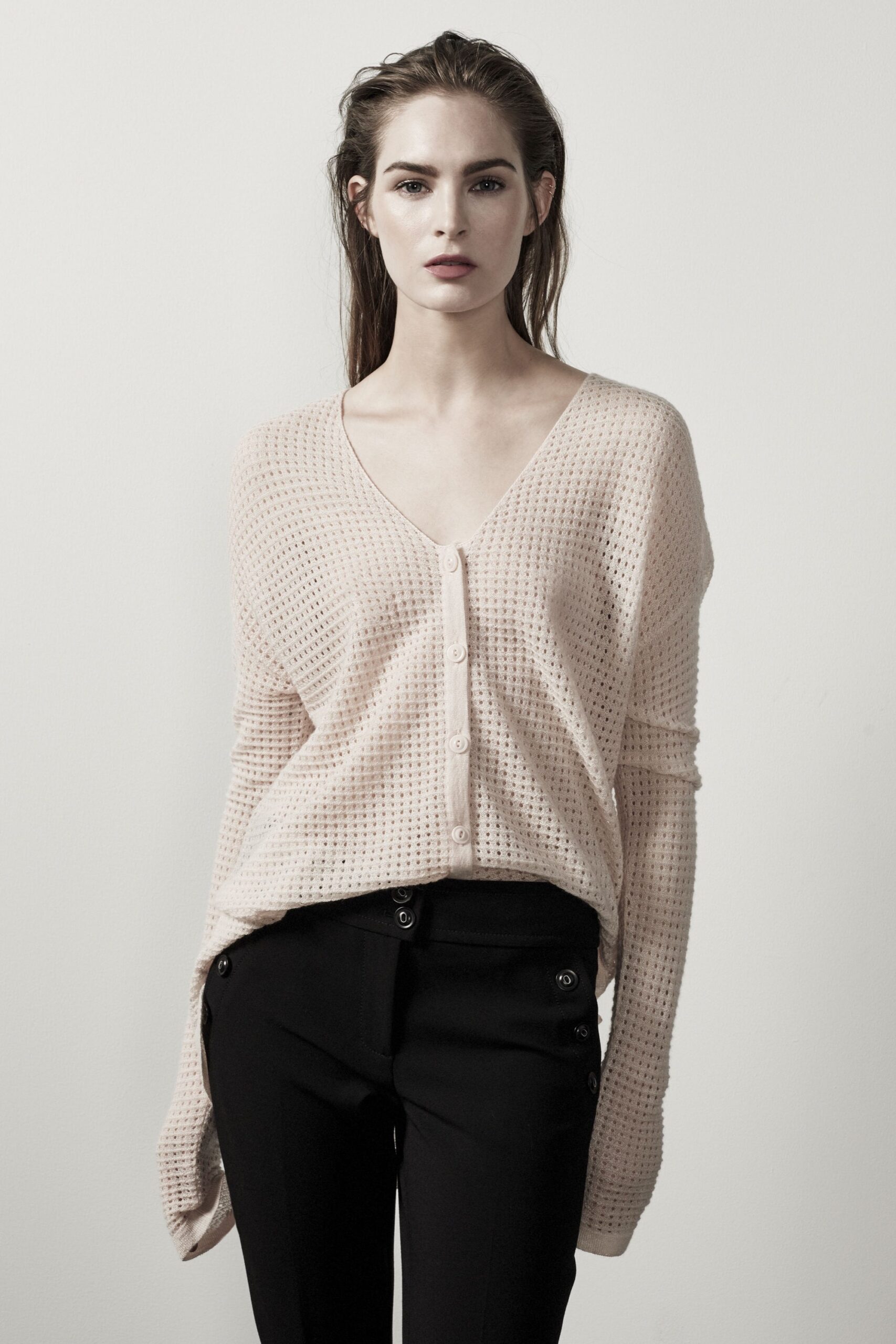 pink relaxed cardigan and black fitted pants