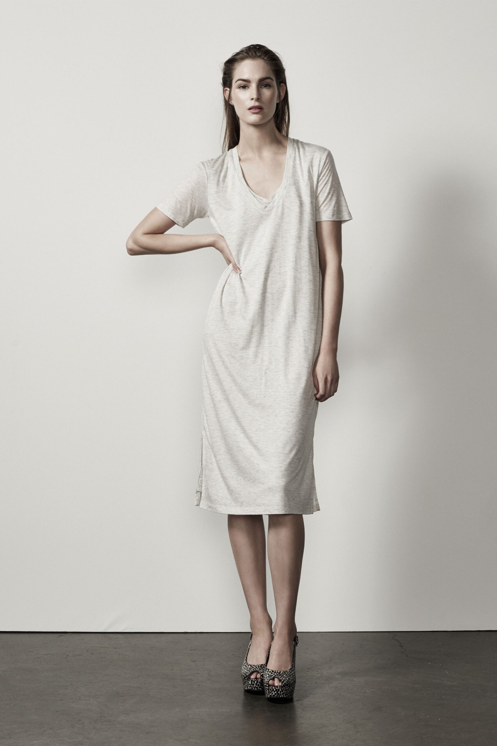 white relaxed midi dress with black embellished shoes