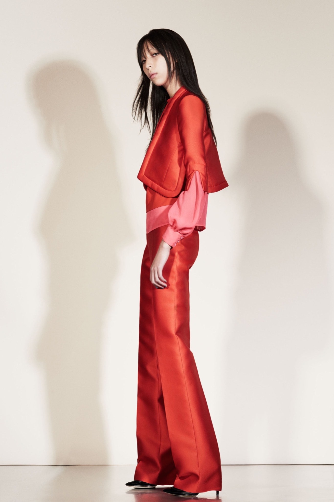 red silk fitted top and tailored pants