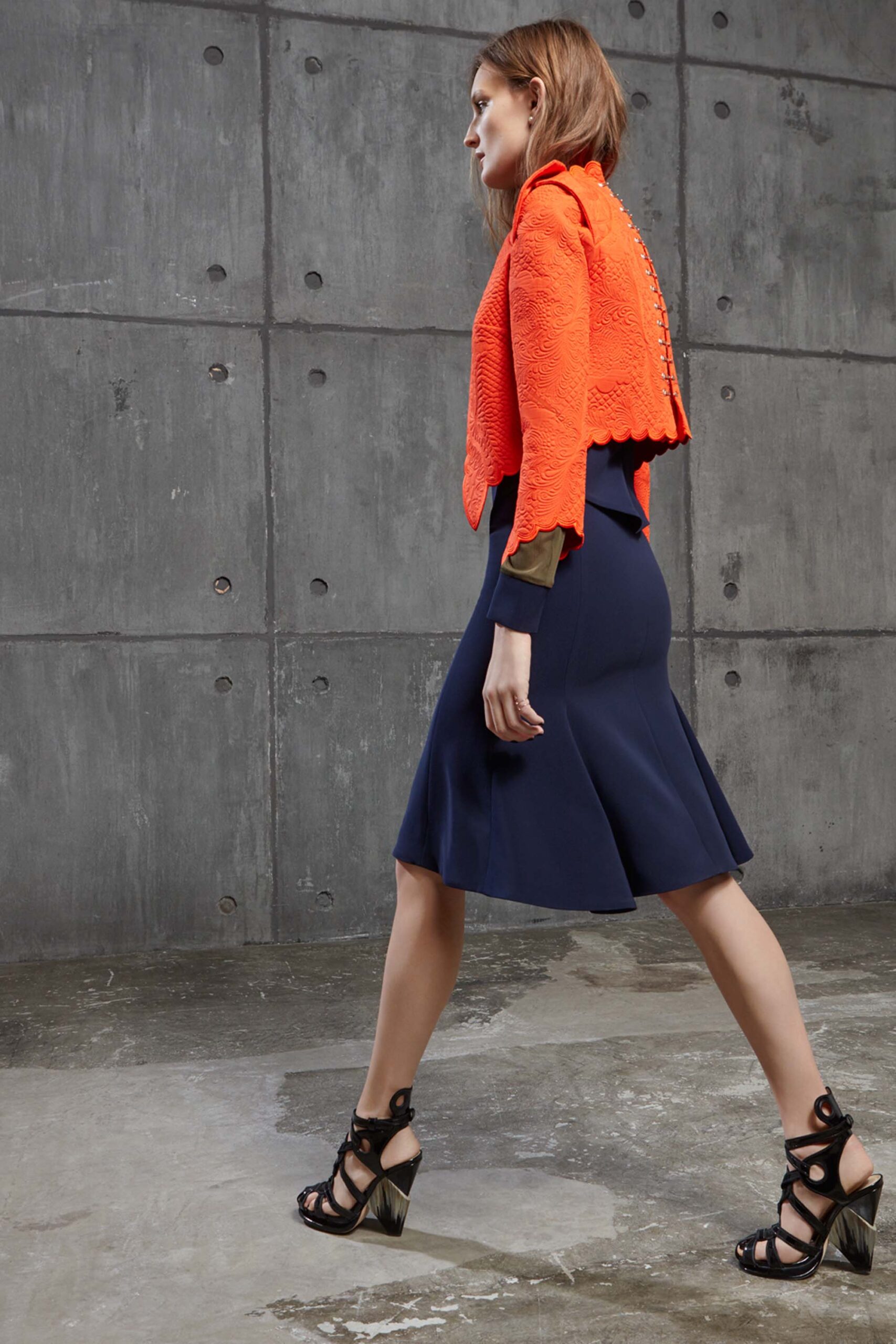 orange fitted jacket with blue flared skirt