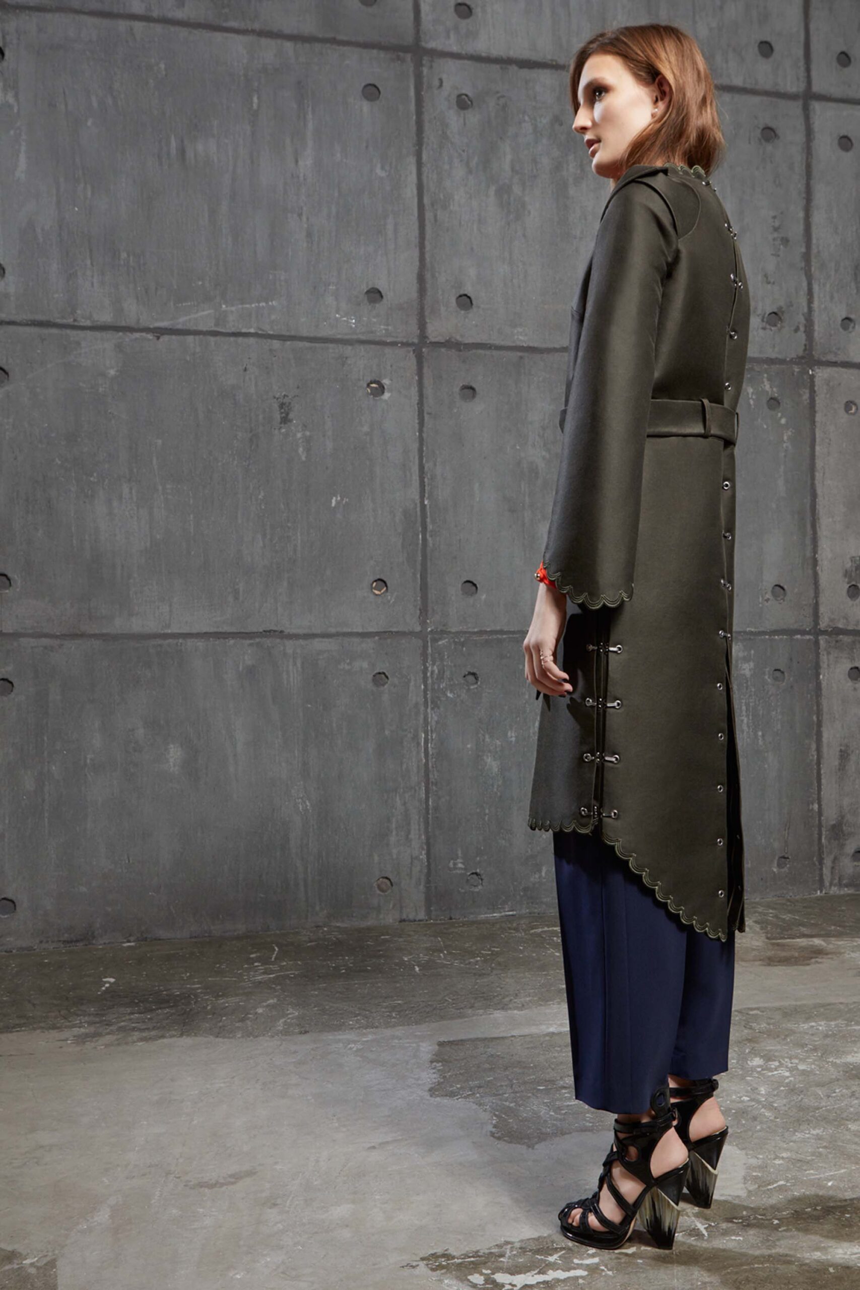 green wool fitted coat with blue pants