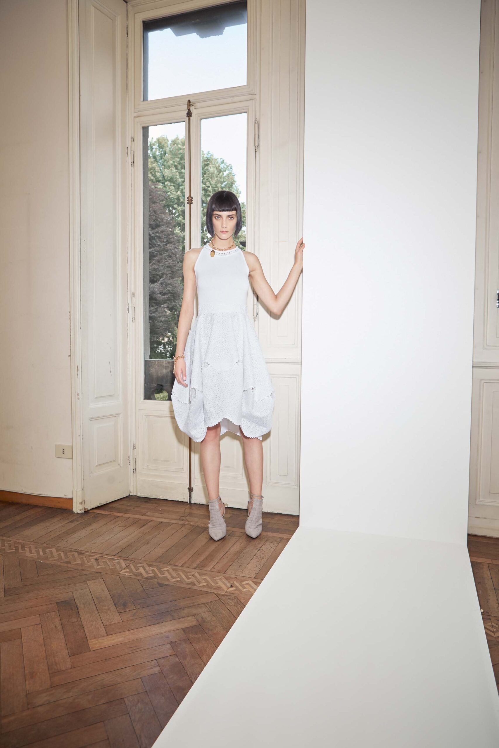 white pleated sleeveless dress
