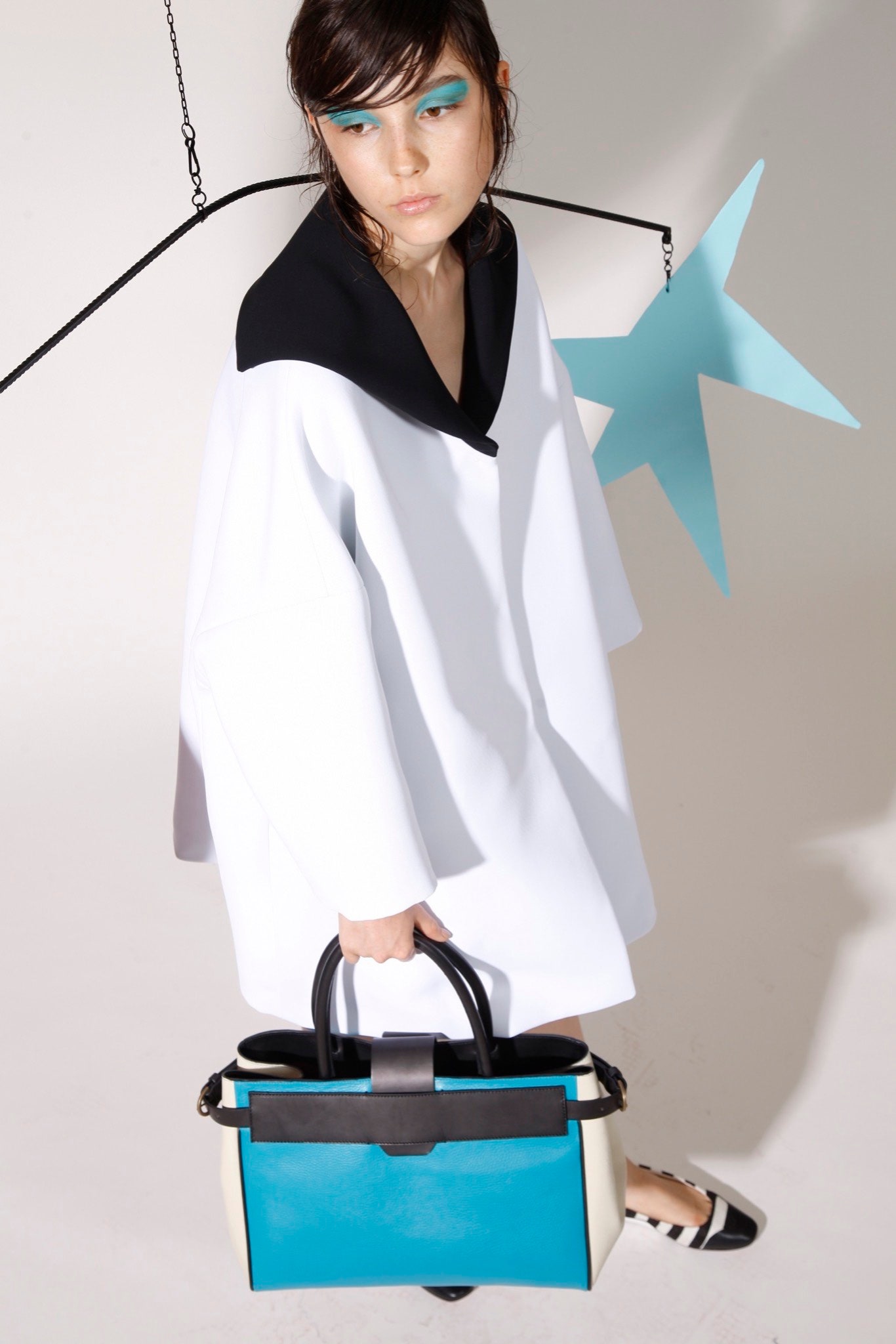 white relaxed cape with color-blocked bag