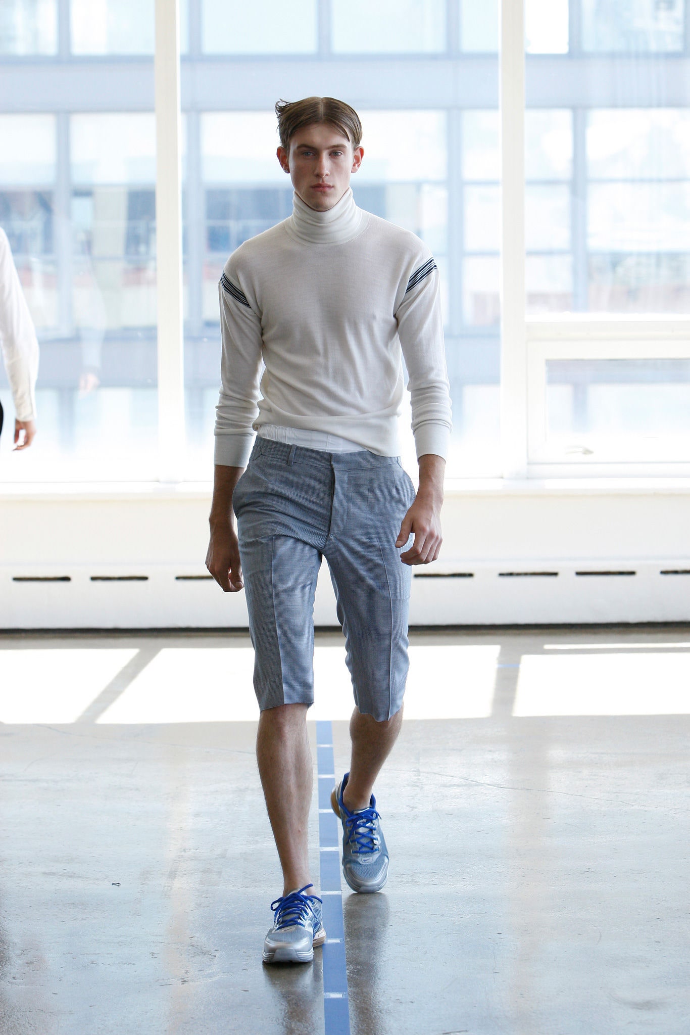 white fitted turtleneck with gray tailored shorts