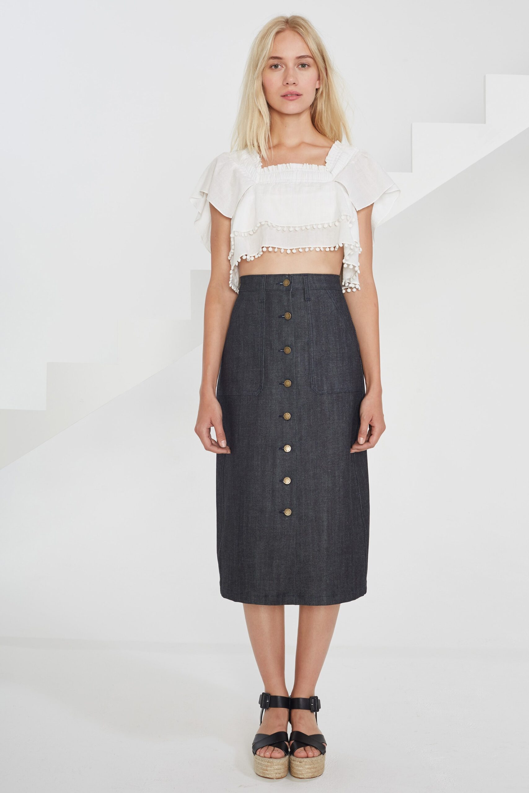 white ruffled top and blue denim skirt