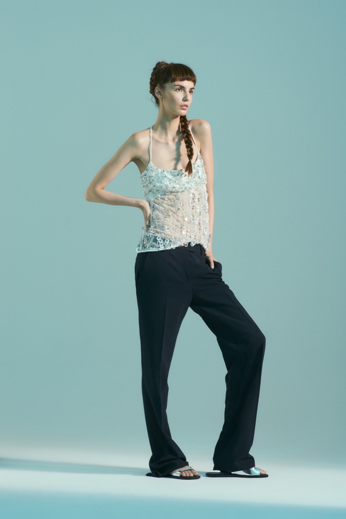 white beaded sleeveless top and black relaxed pants