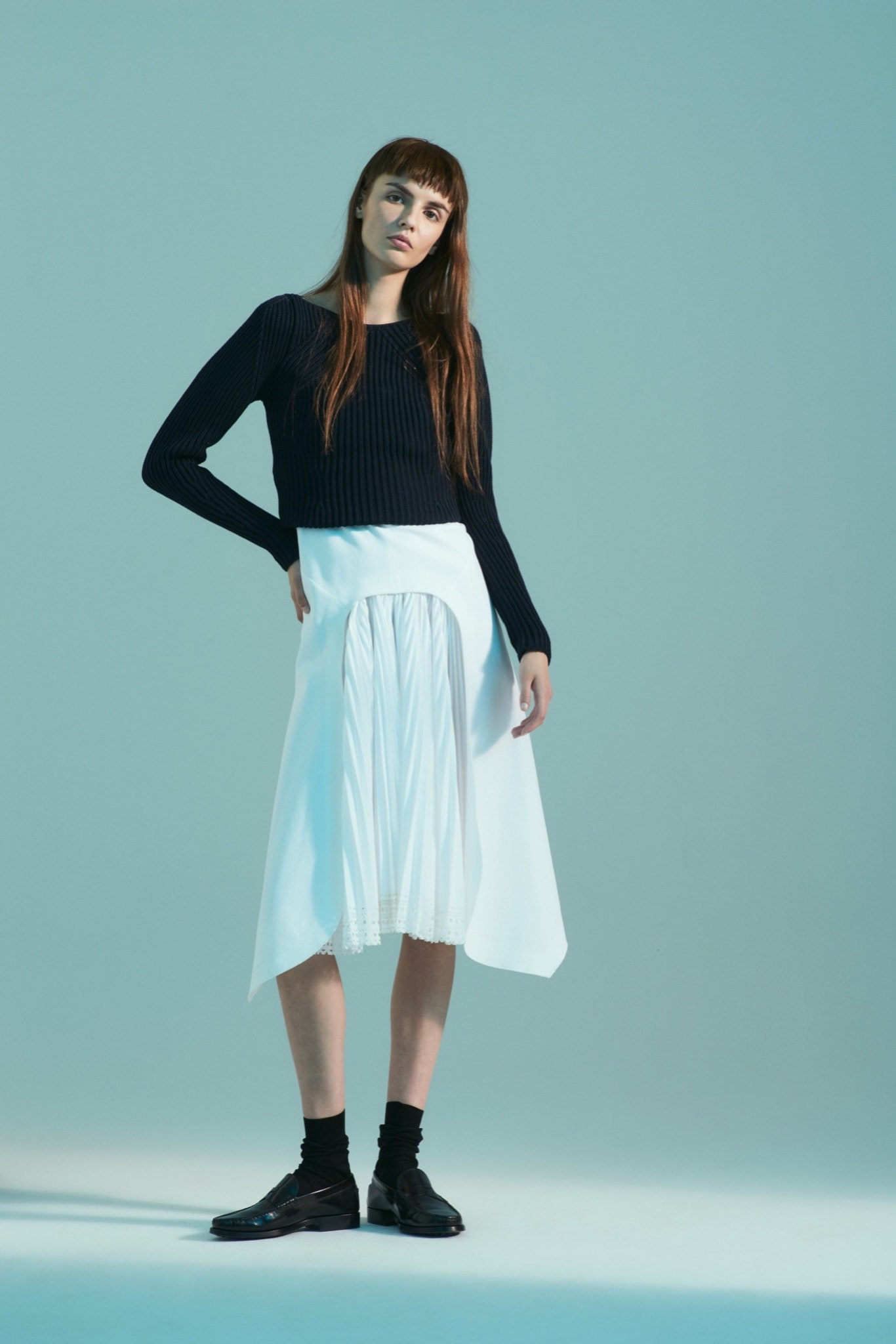 black fitted knit top and white pleated skirt