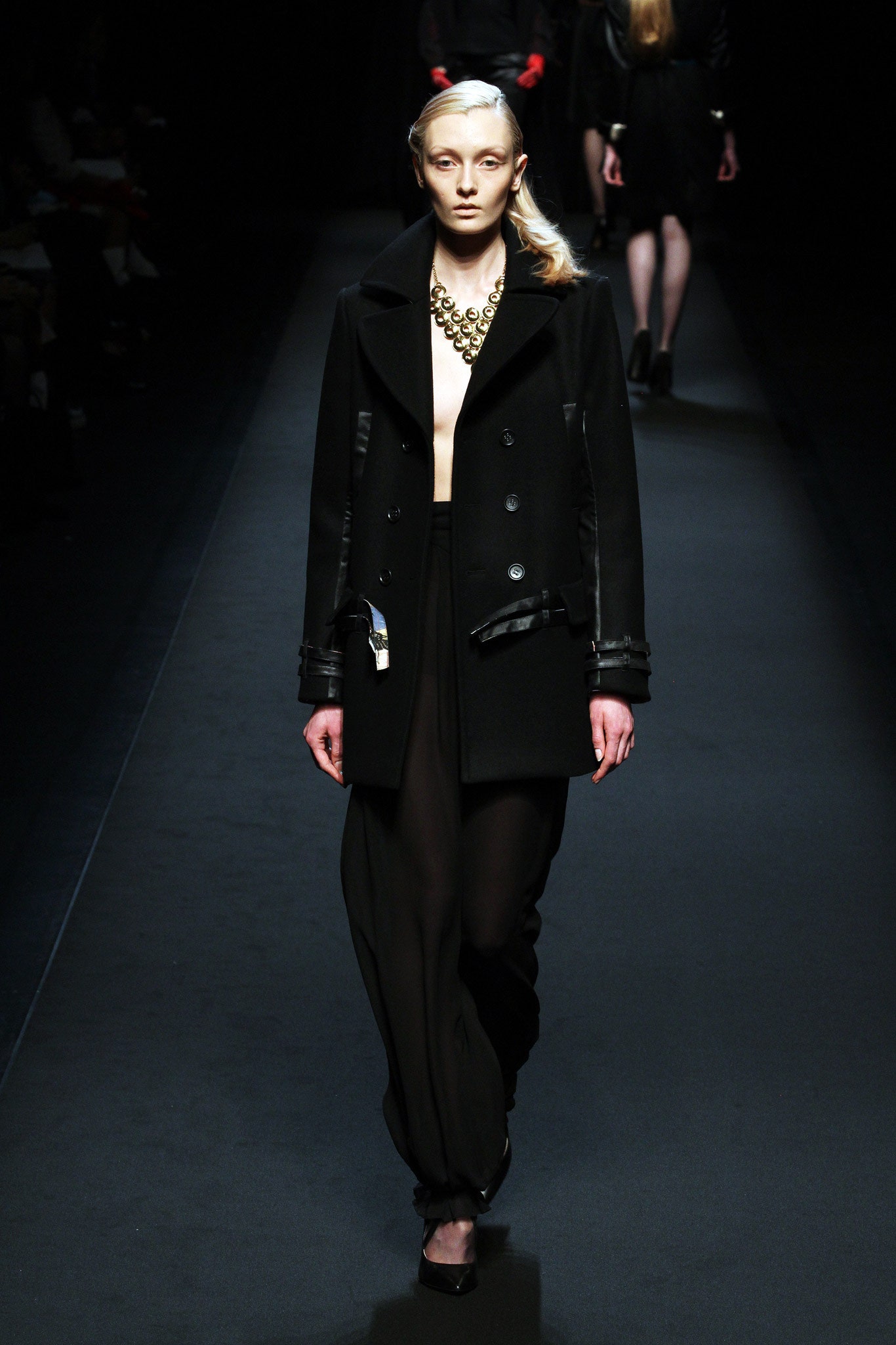 black fitted coat with relaxed pants