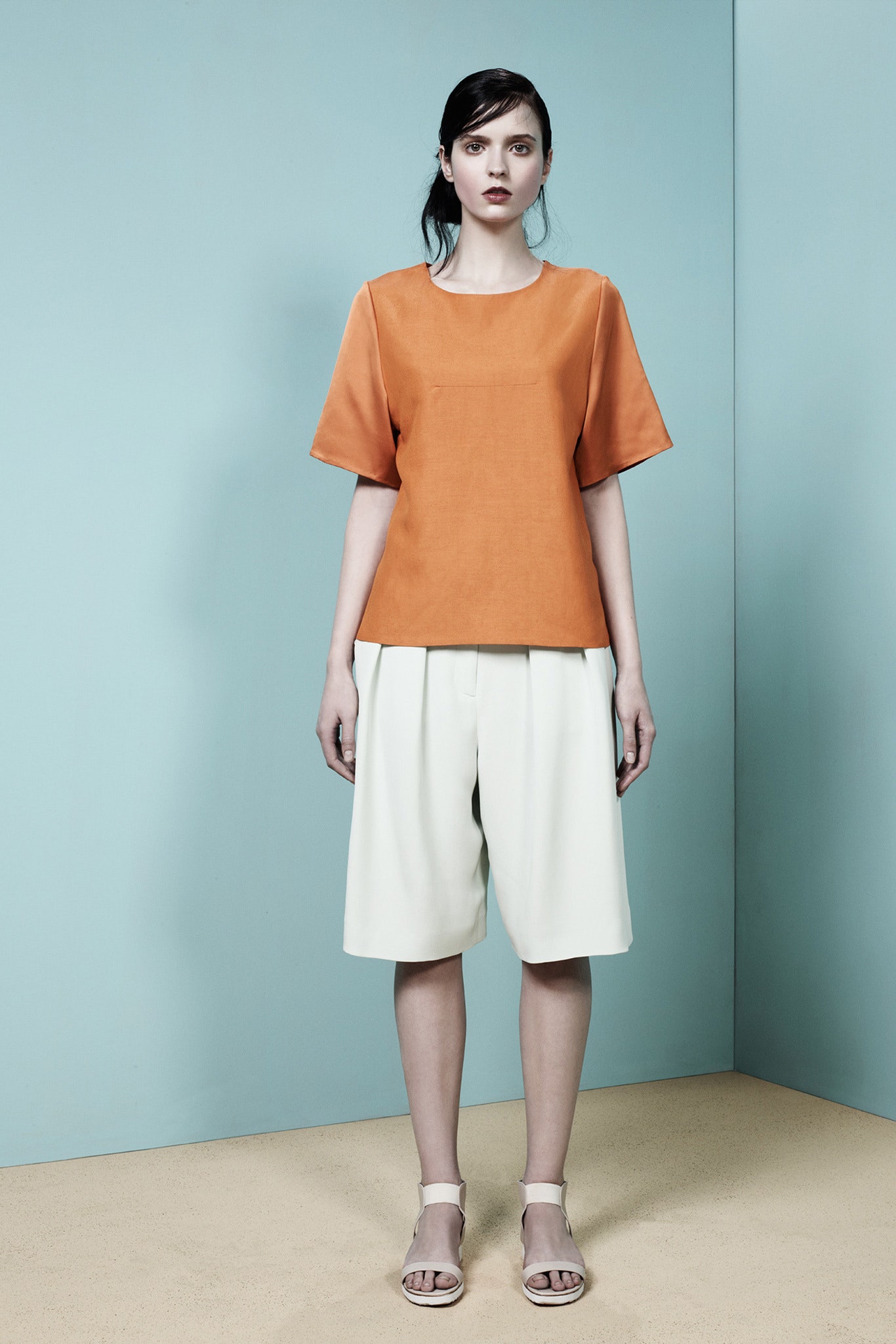 orange relaxed top with white shorts