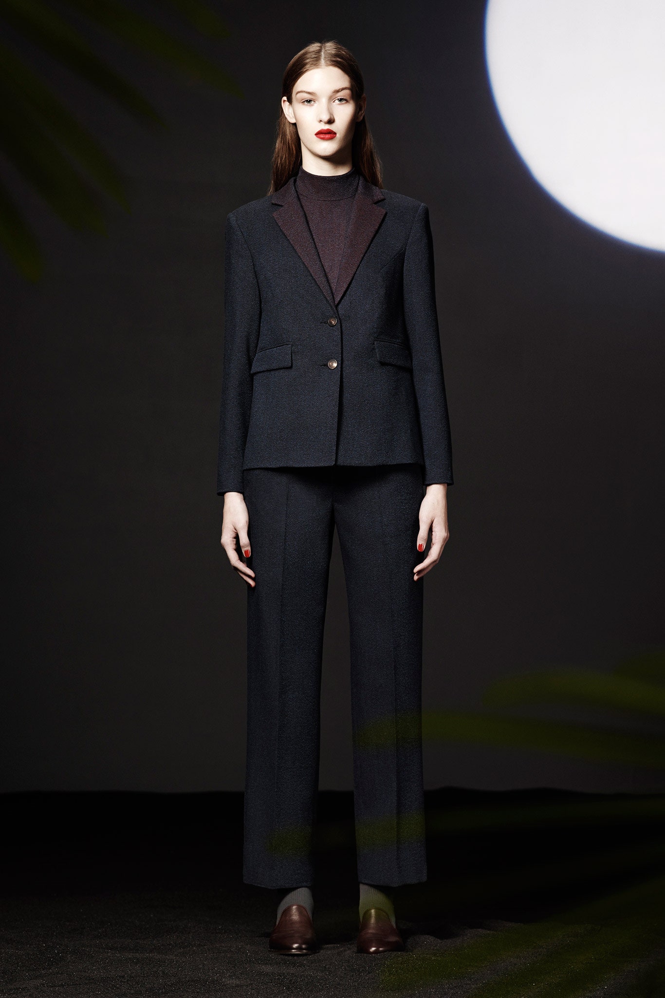 black tailored suit with high-neck top