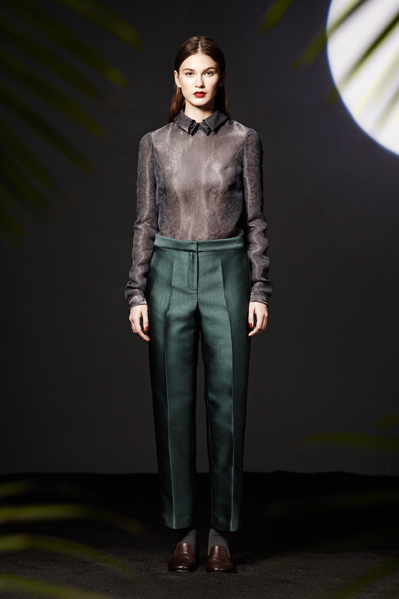 black sheer silk shirt and green tailored pants