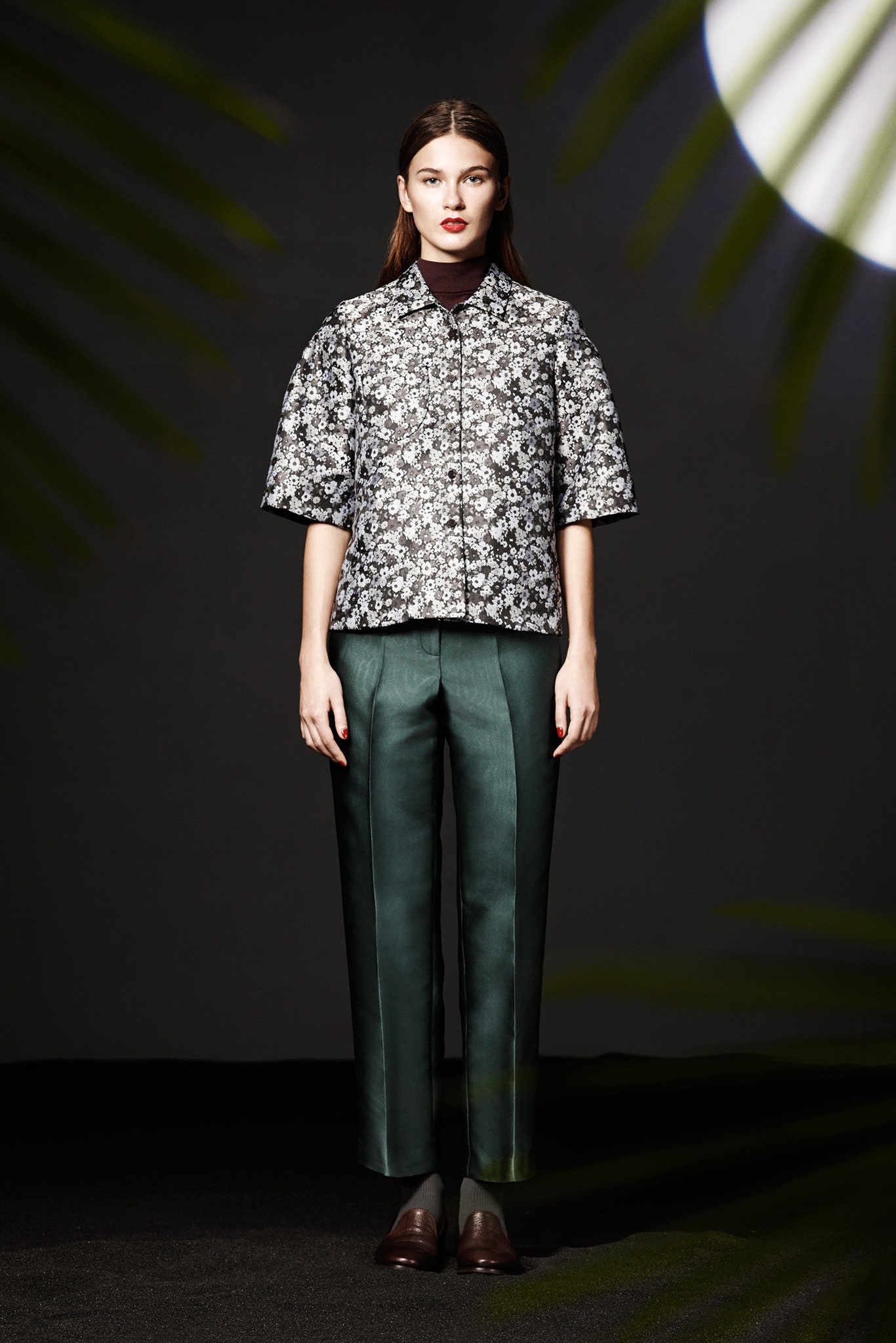 printed black and white top with tailored green pants