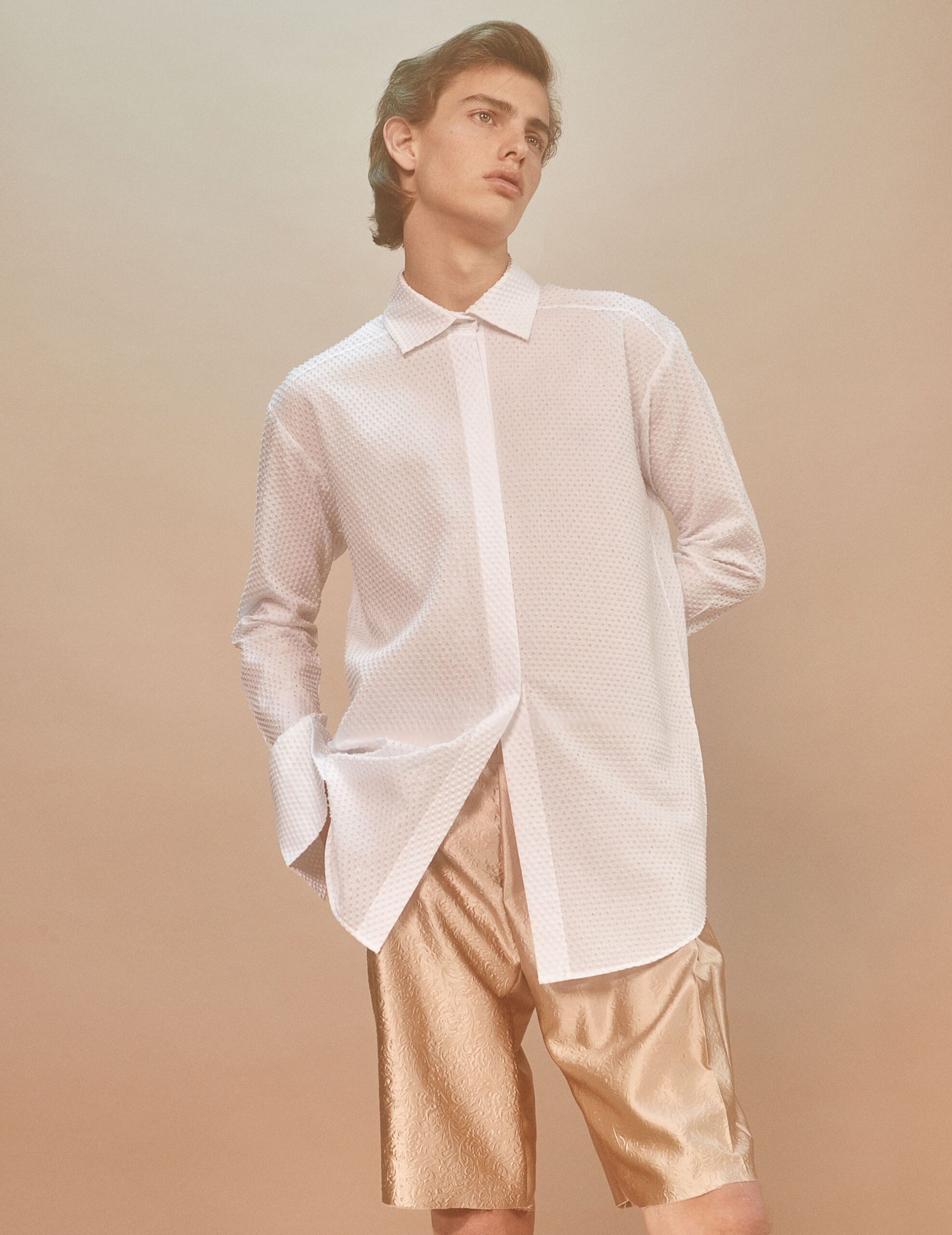 white relaxed shirt and gold shorts