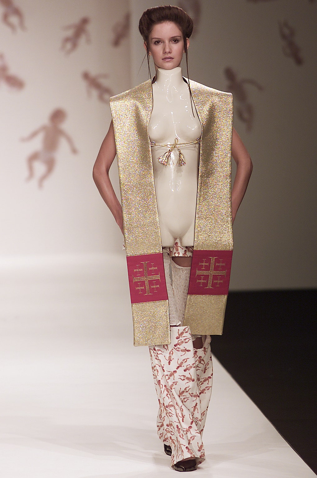 gold vinyl sleeveless coat with beige flared pants