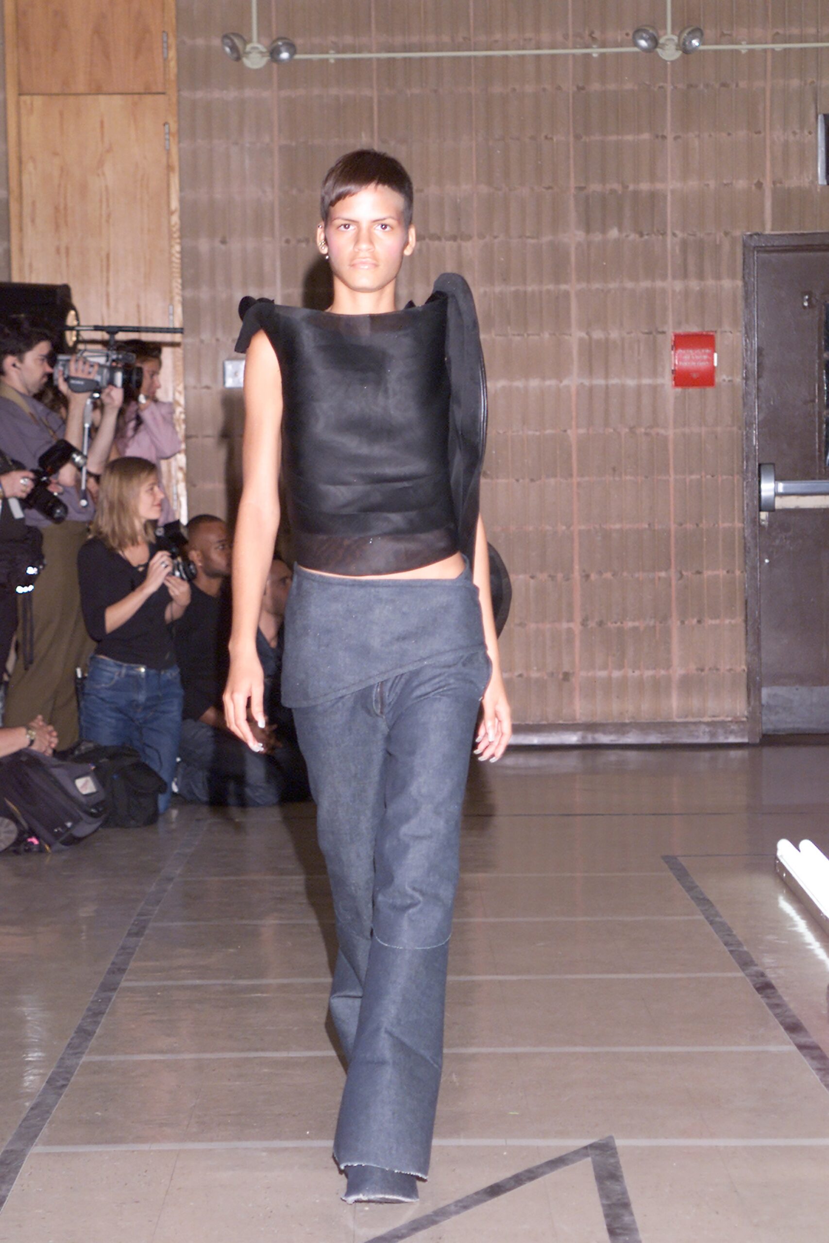 black leather fitted top and blue denim pants