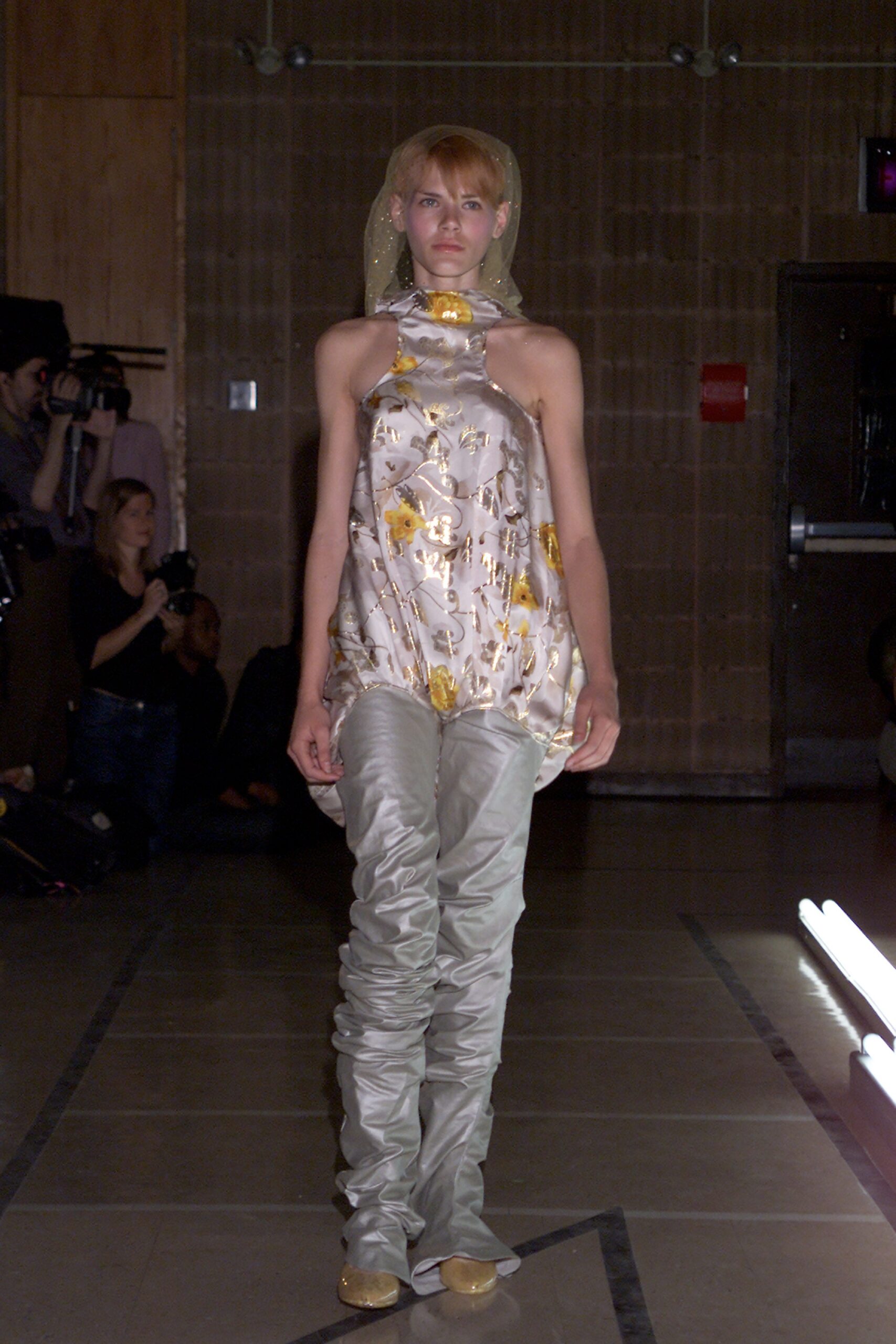 fitted white silk top with gray pants