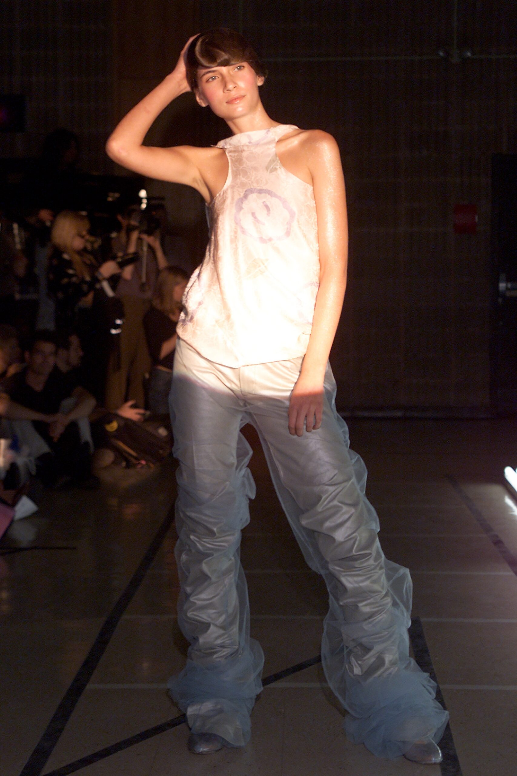 white silk sleeveless top and light blue pants