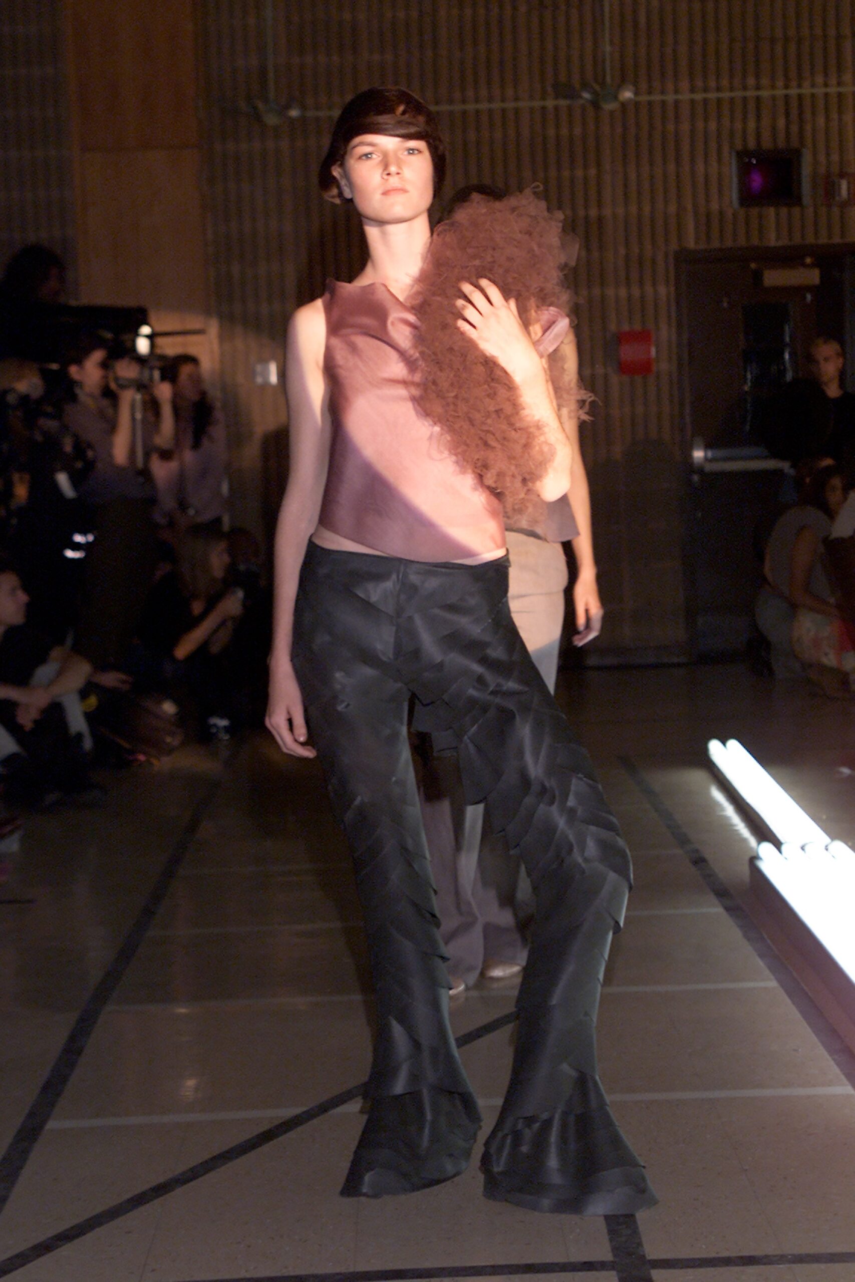pink silk sleeveless top and black flared pants