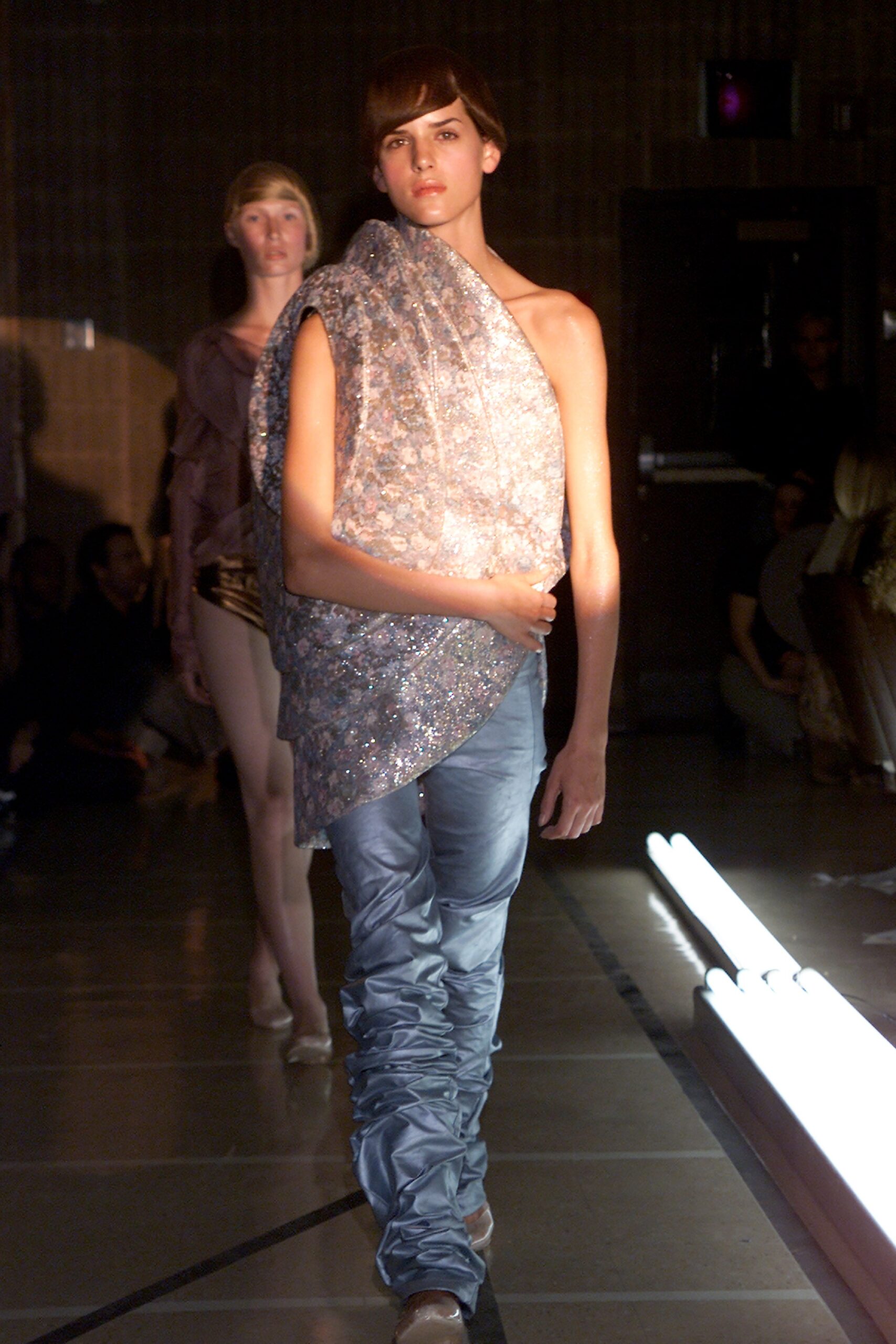 shiny silver asymmetric top with blue pants