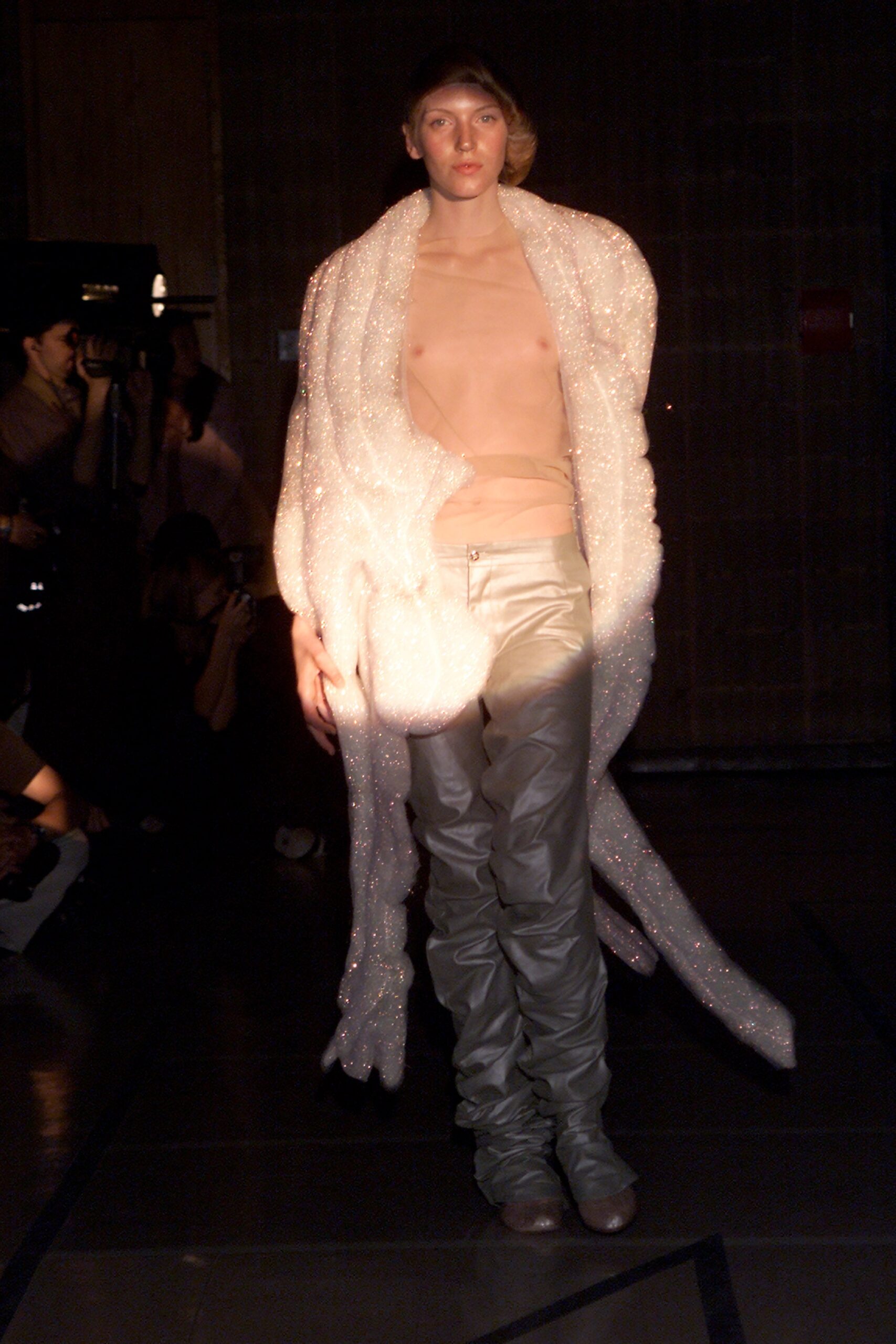 shiny silver fitted pants and draped white coat