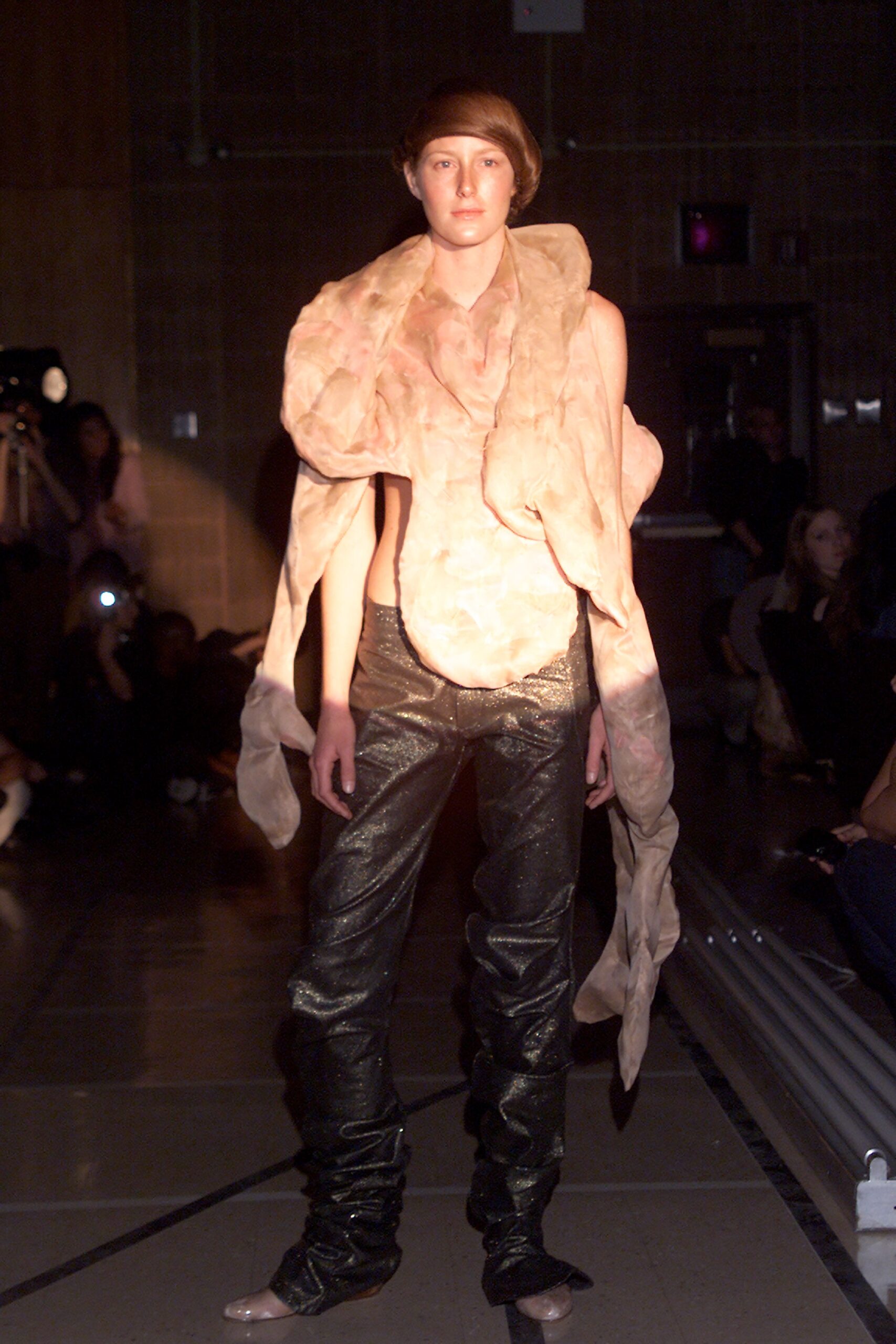 pink draped top and black vinyl pants