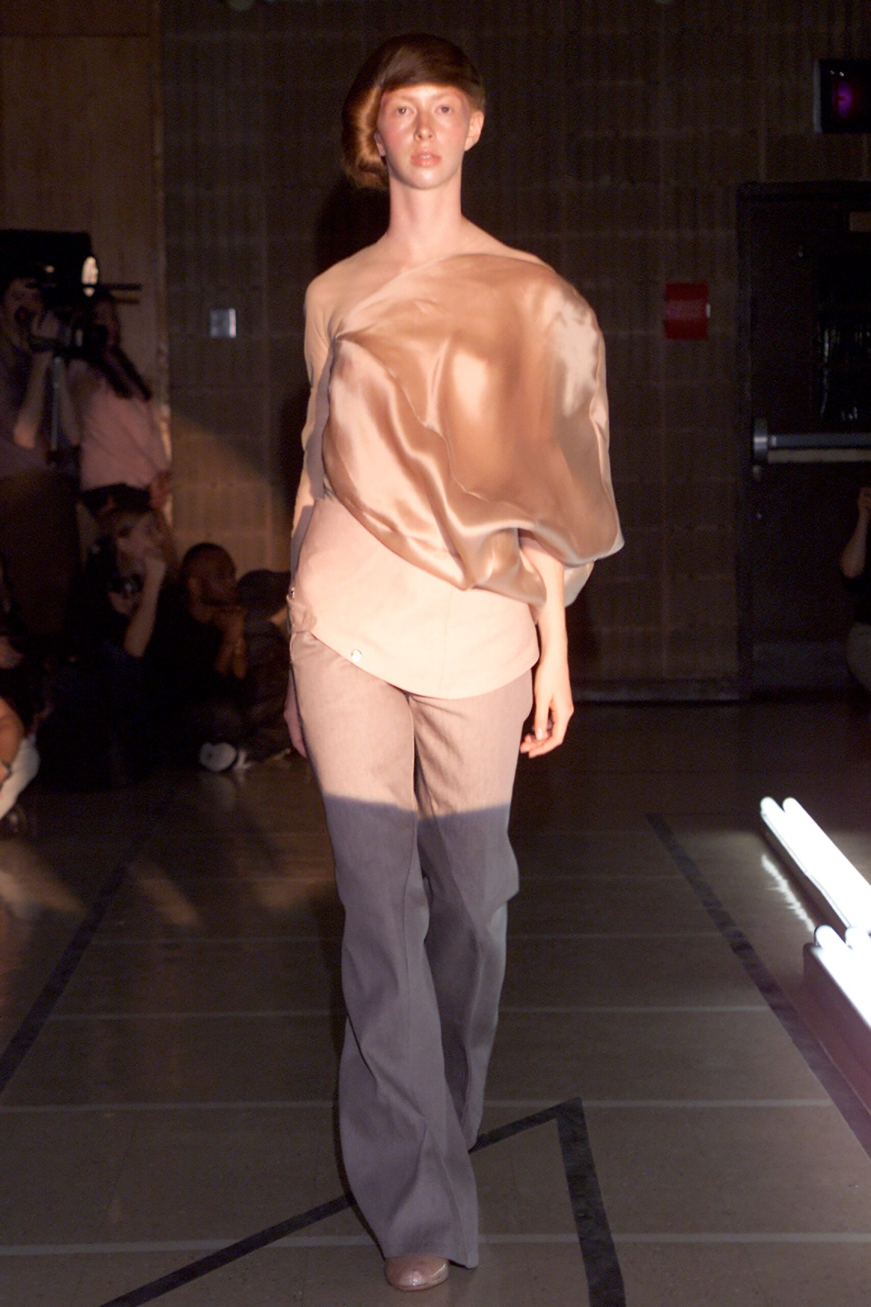 beige silk off-shoulder top with gray pants