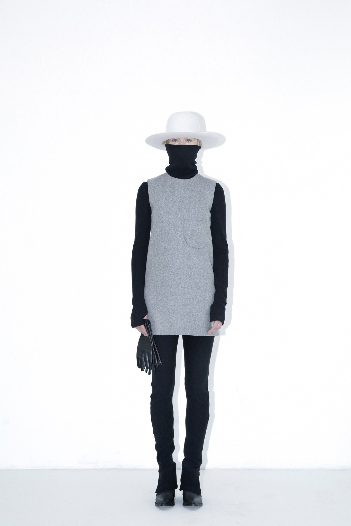 gray sleeveless top with black pants