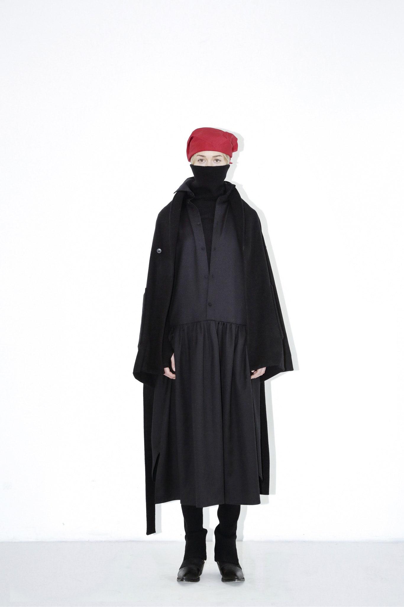 black coat and dress with red headscarf