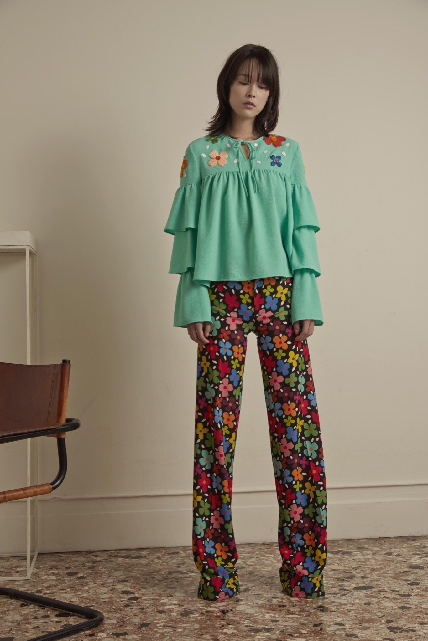 green ruffled top with flared pants