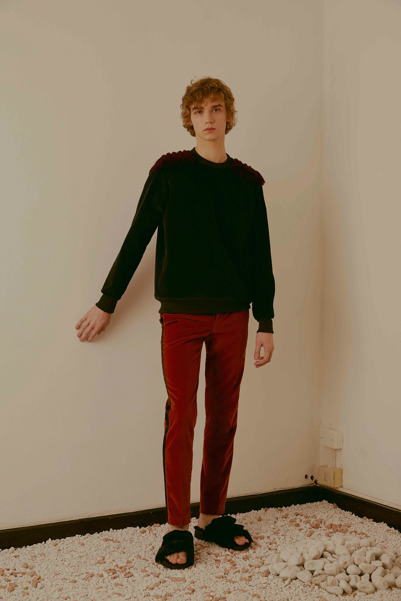 black relaxed sweater with red pants