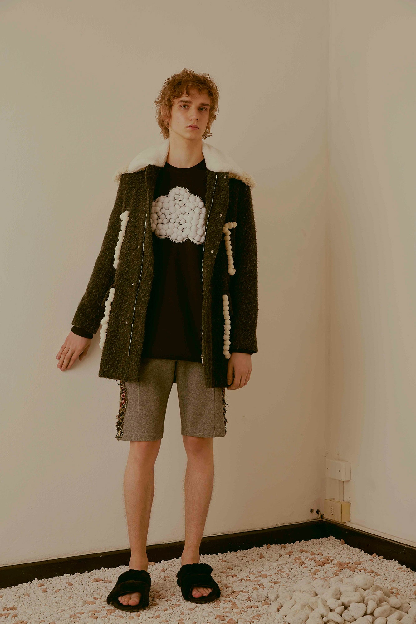 black wool coat with t-shirt and shorts