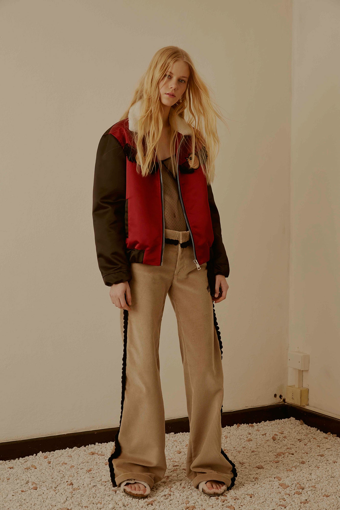 fitted black and red jacket with beige top and pants