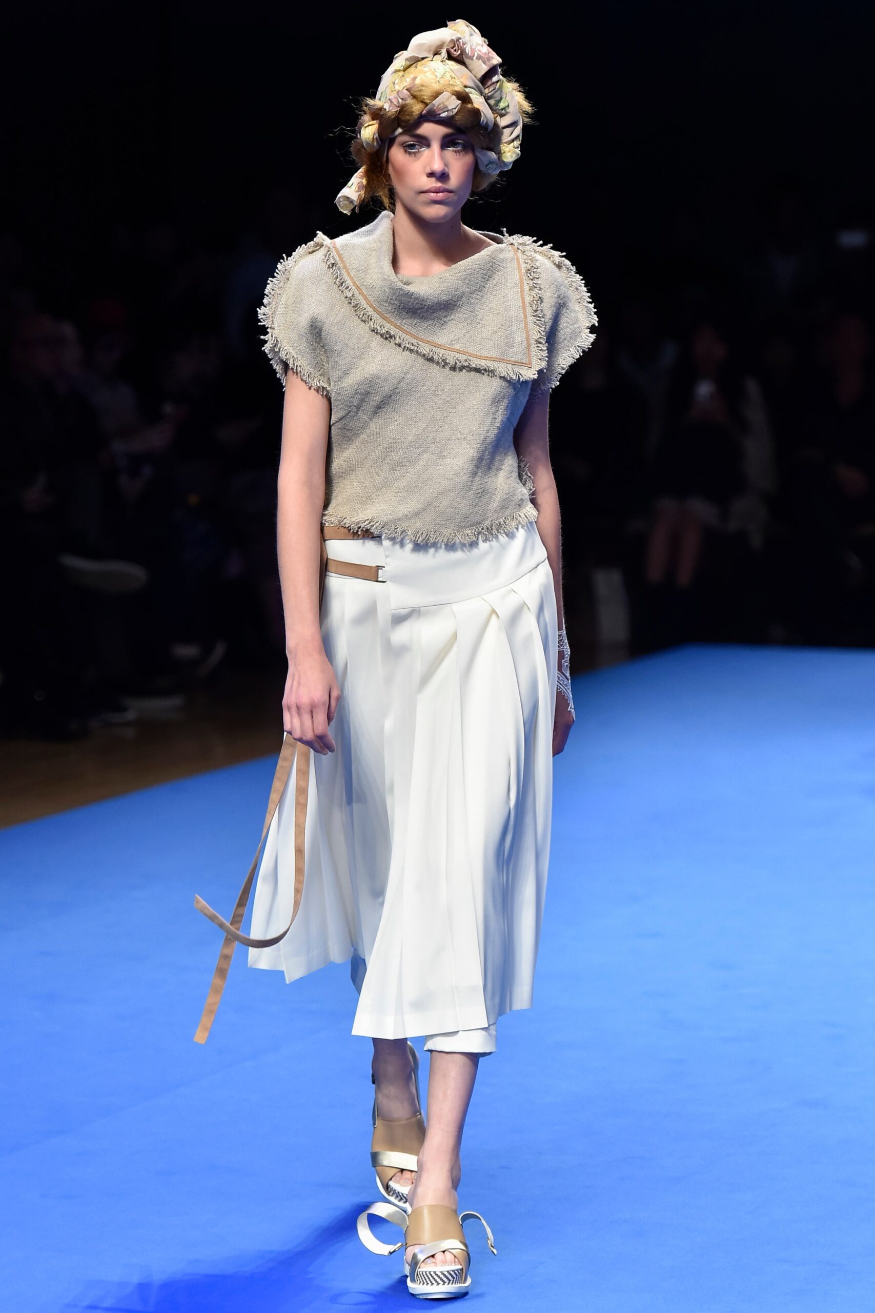 beige relaxed top with white pleated pants