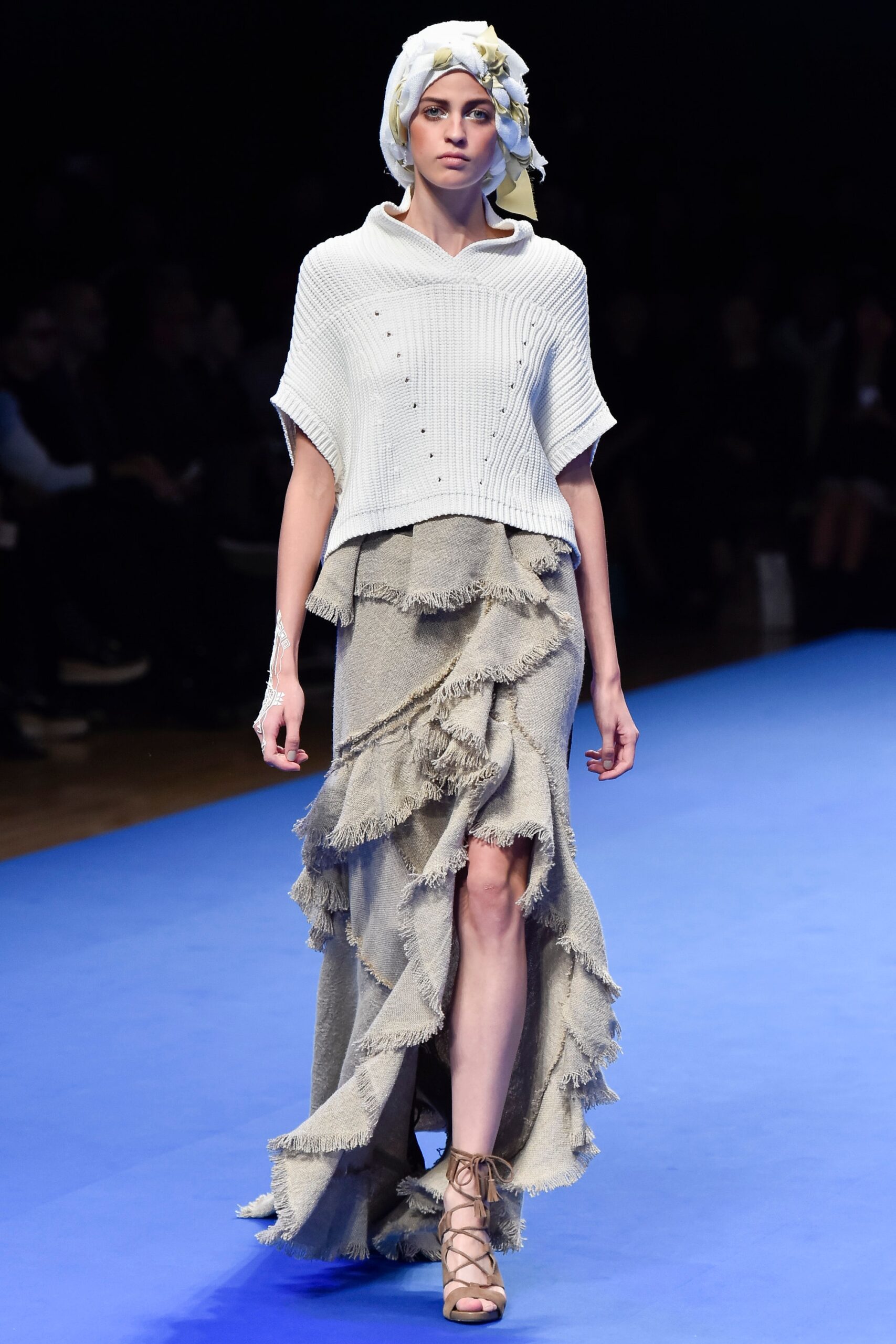 white relaxed top and beige ruffled skirt