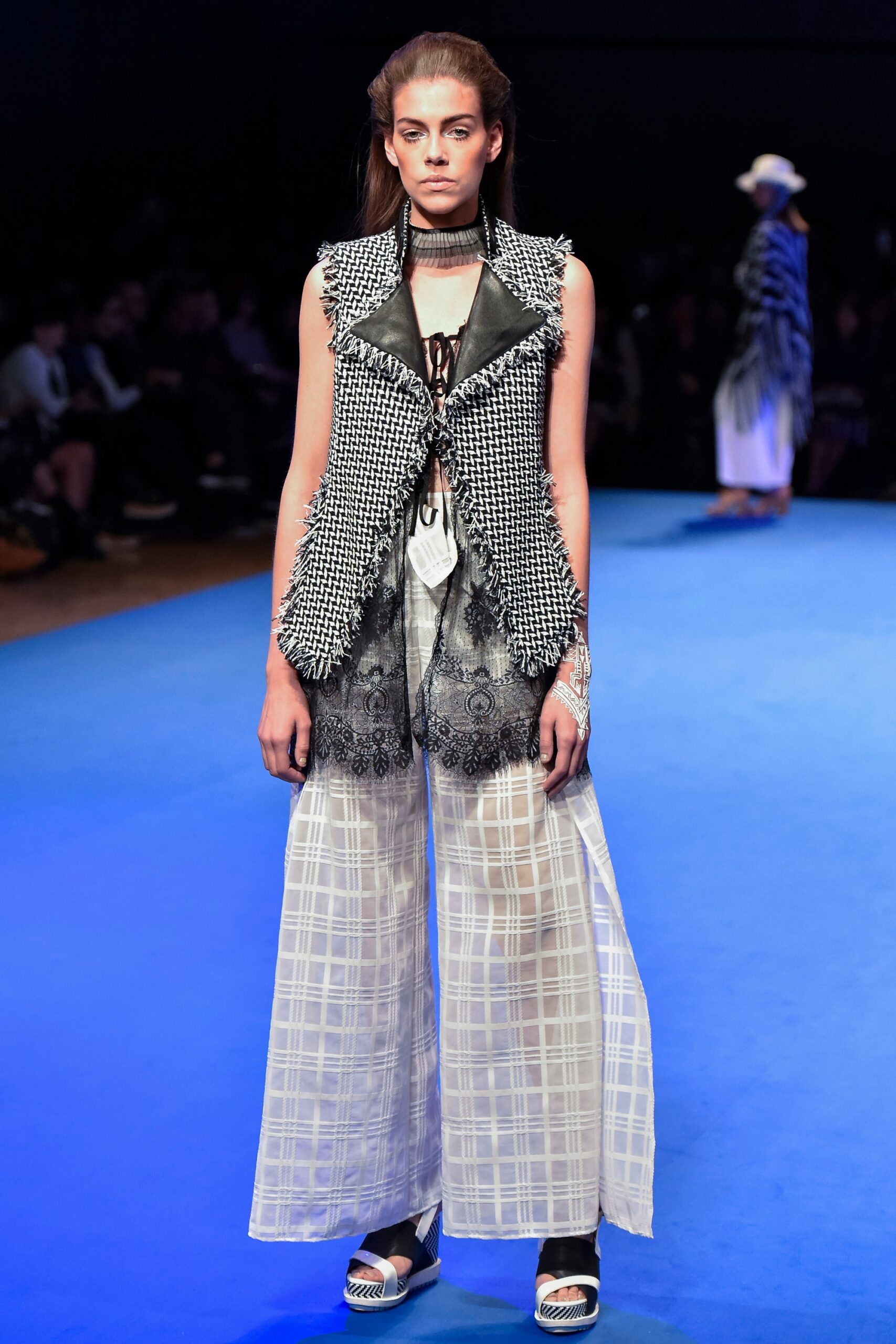 black and white layered vest with wide-leg pants