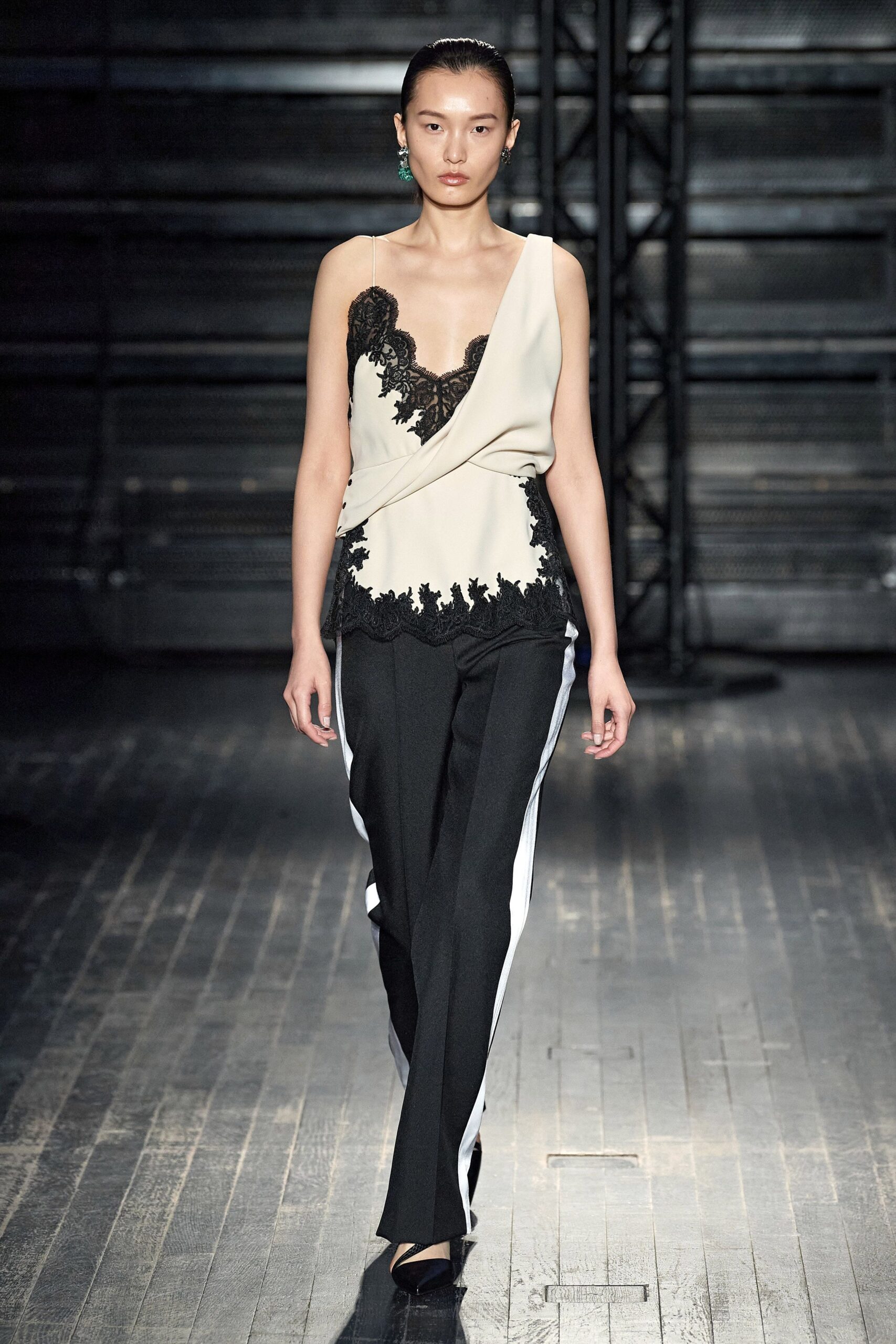 beige embroidered sleeveless top with black tailored pants