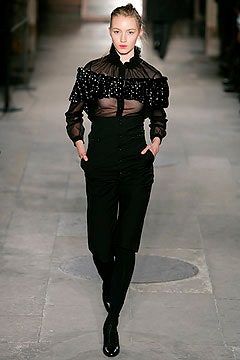black sheer ruffled blouse and fitted pants