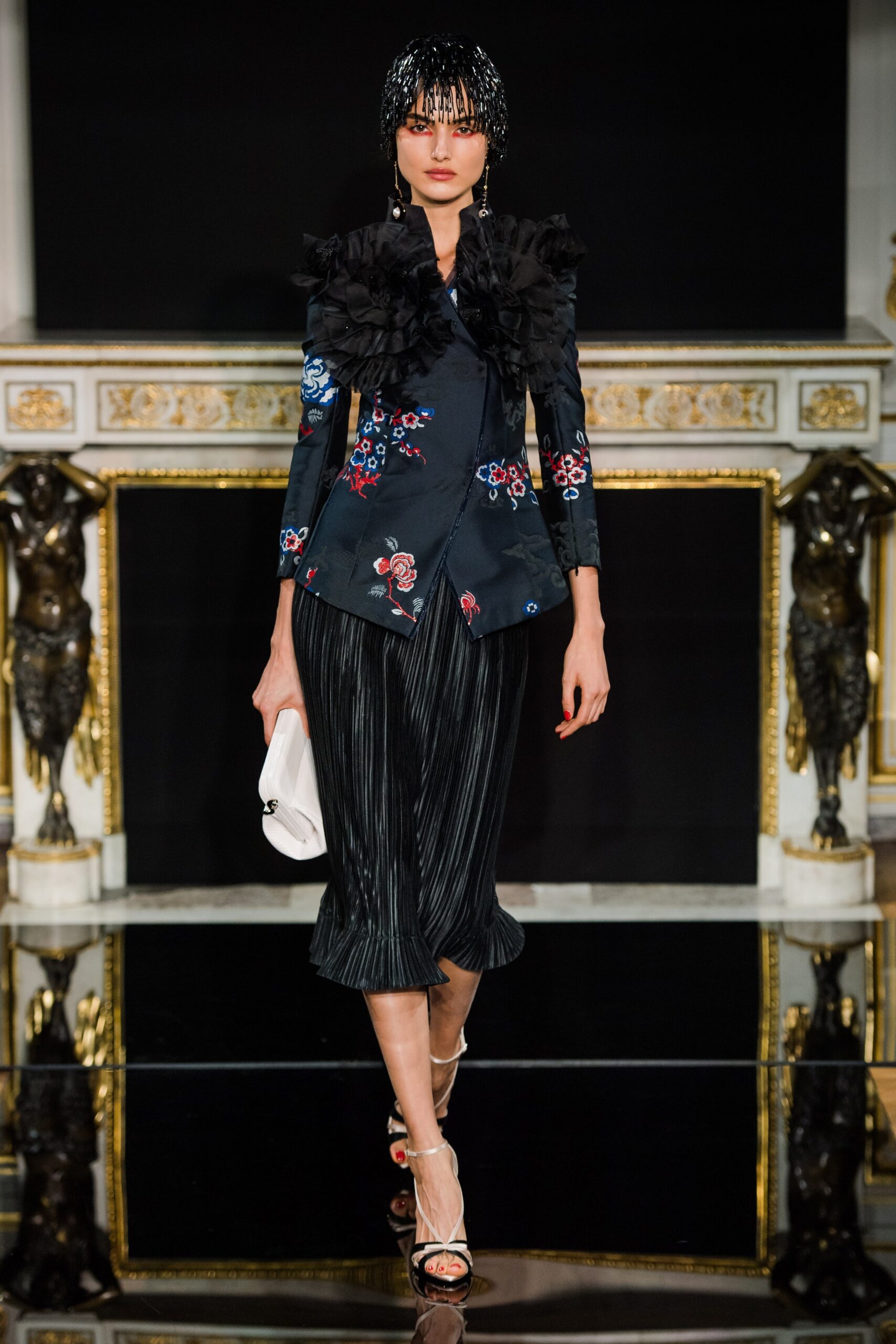 black silk blouse and pleated skirt