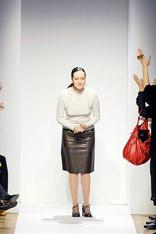 beige fitted wool top and black leather pencil skirt
