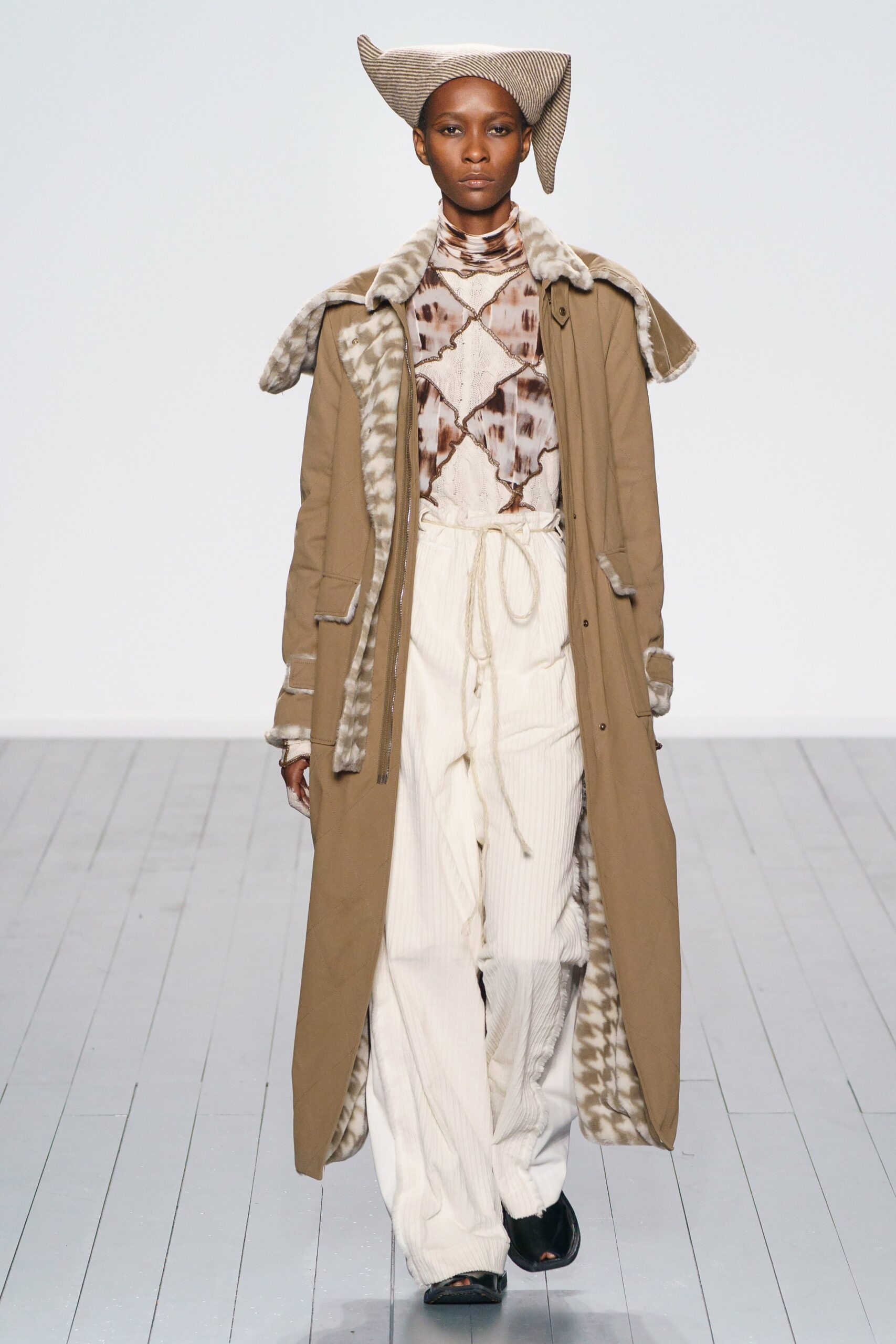 beige coat brown blouse white pants