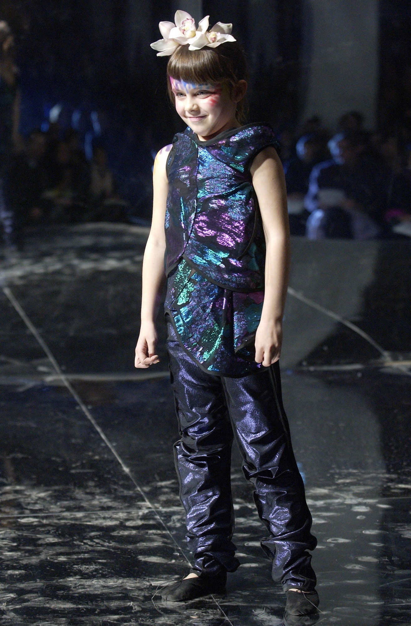 shiny purple and black top with slim pants