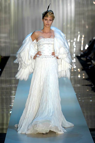 white silk pleated gown with feather cape